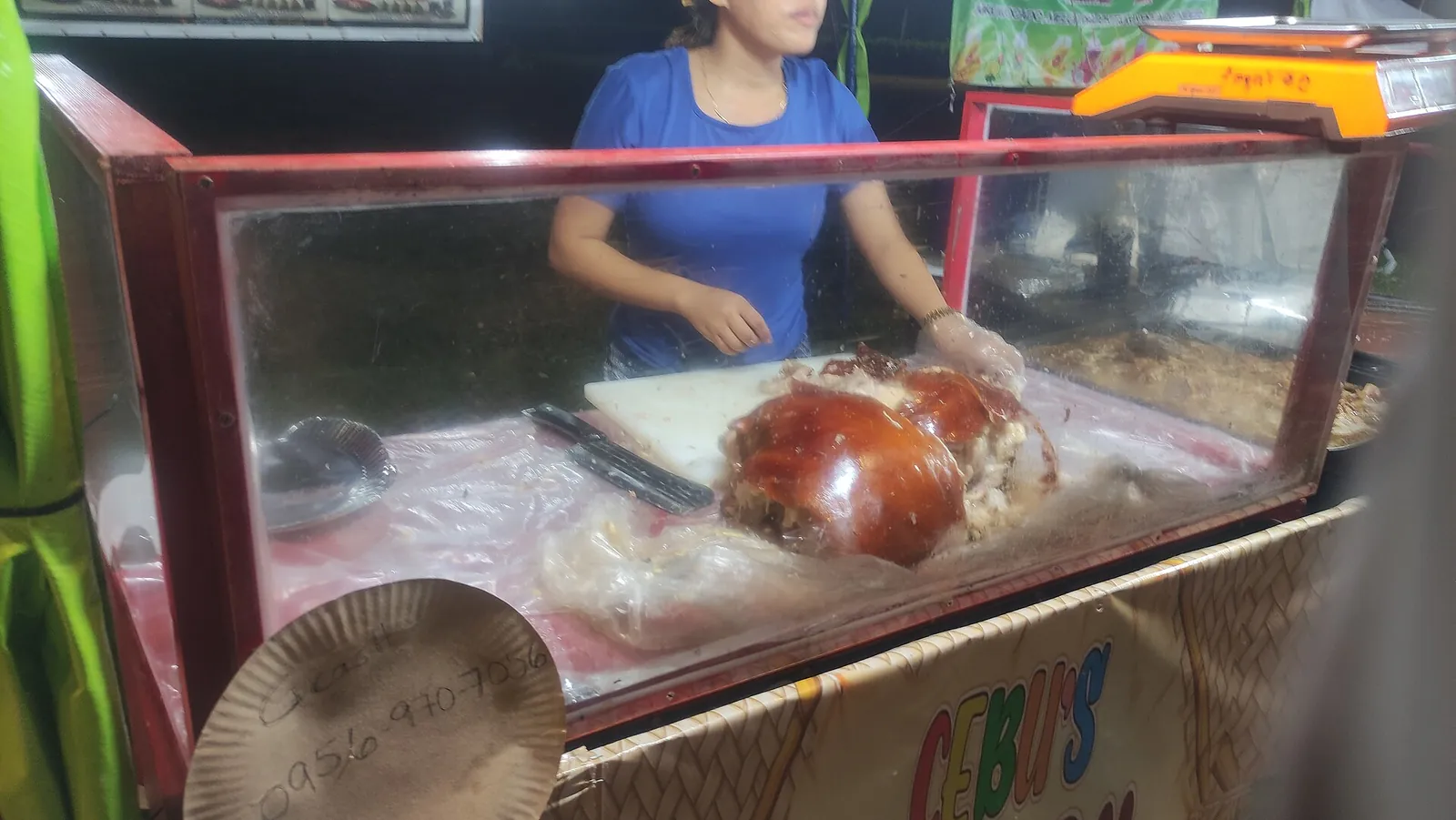 Vendor portioning lechon at a Cebu food stall