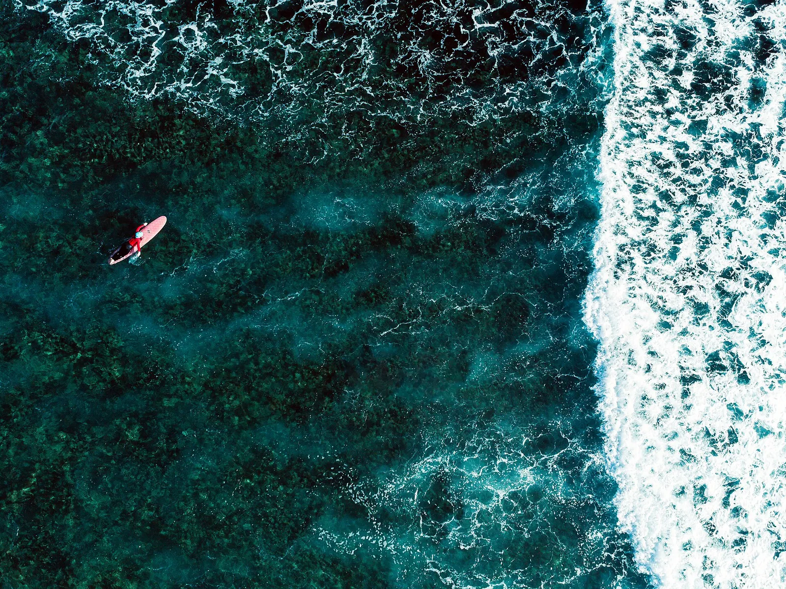 Surfer and reef on Siargao