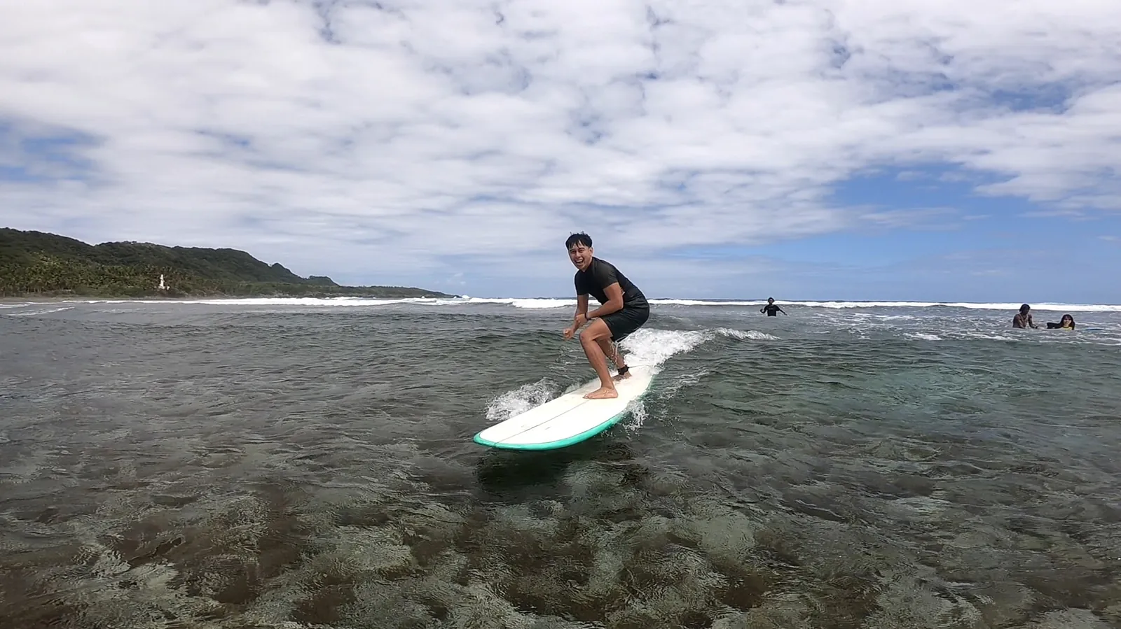 Surfer riding a wave on Siargao