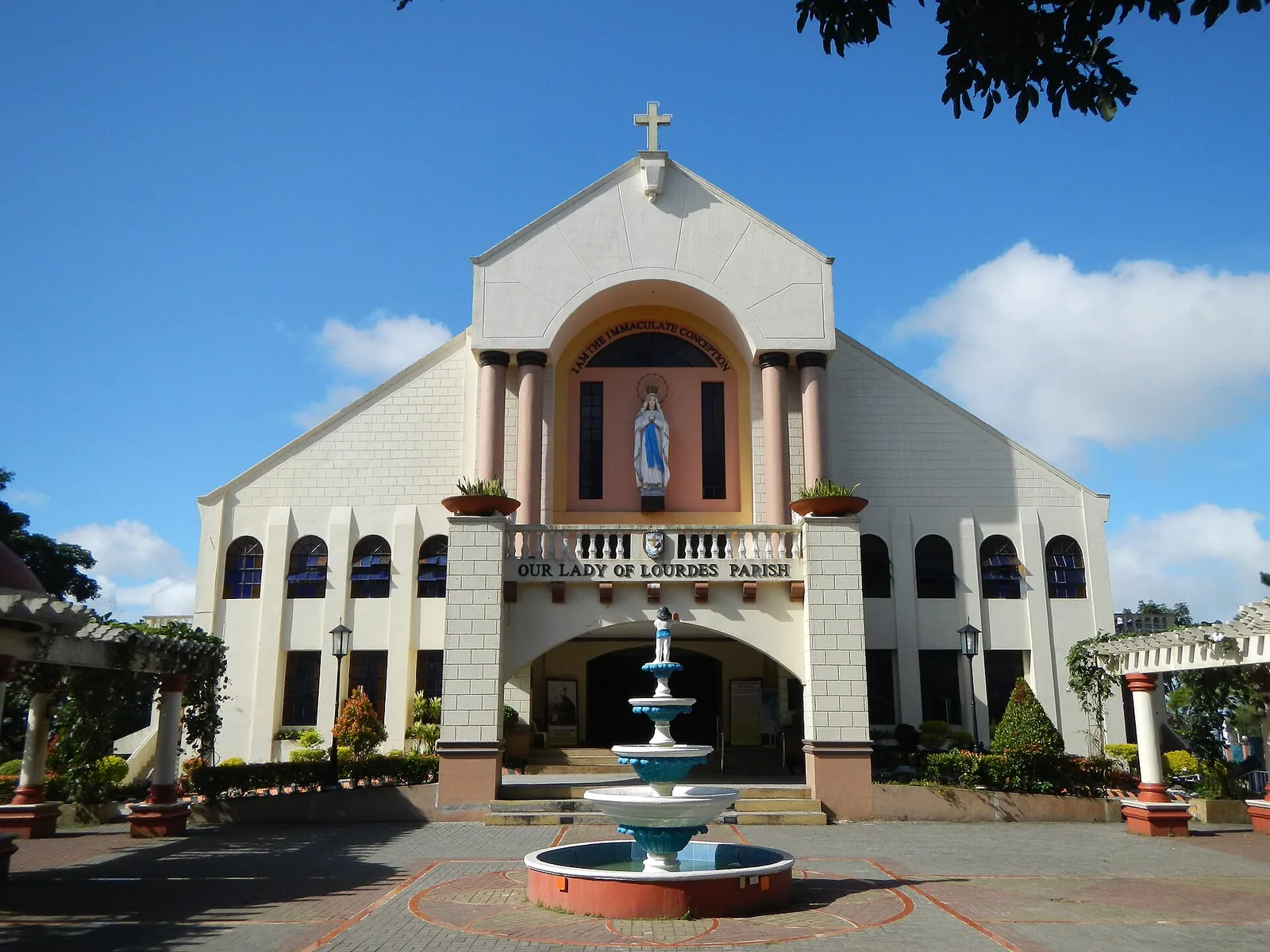 White facade and fountain outside Our Lady of Lourdes Church in Tagaytay