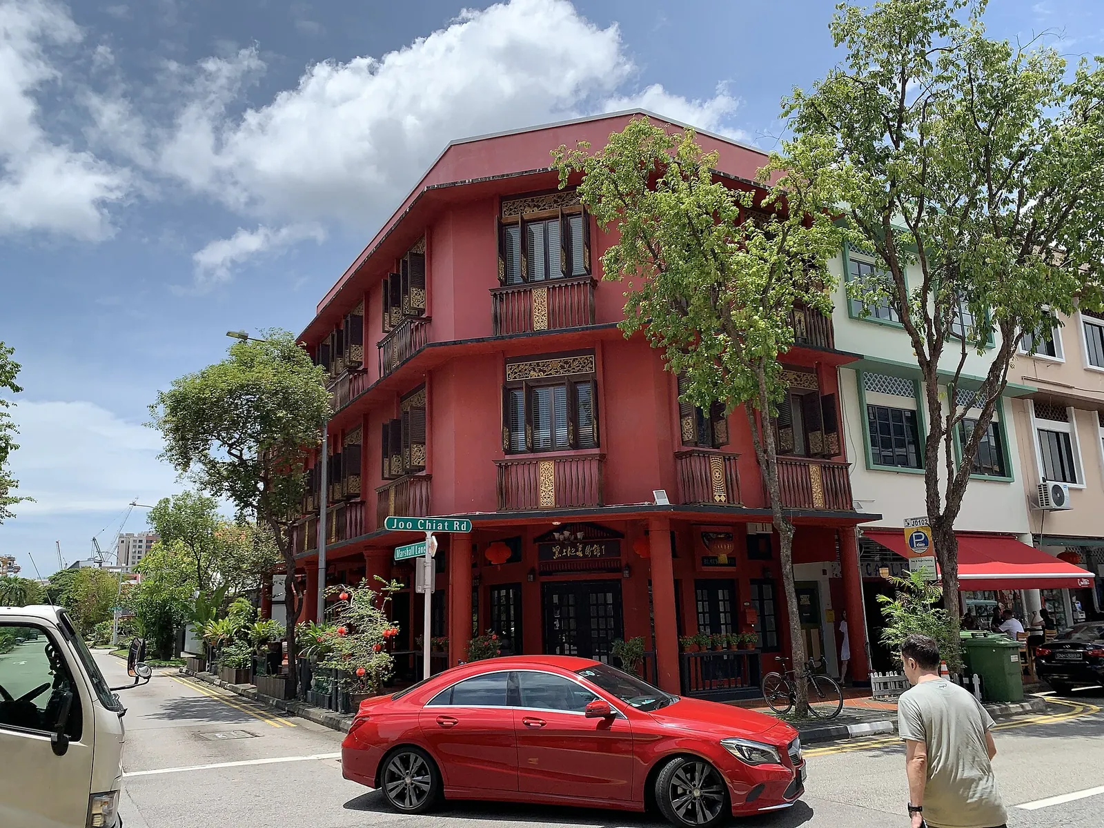Red shophouse on Joo Chiat Road at a street corner