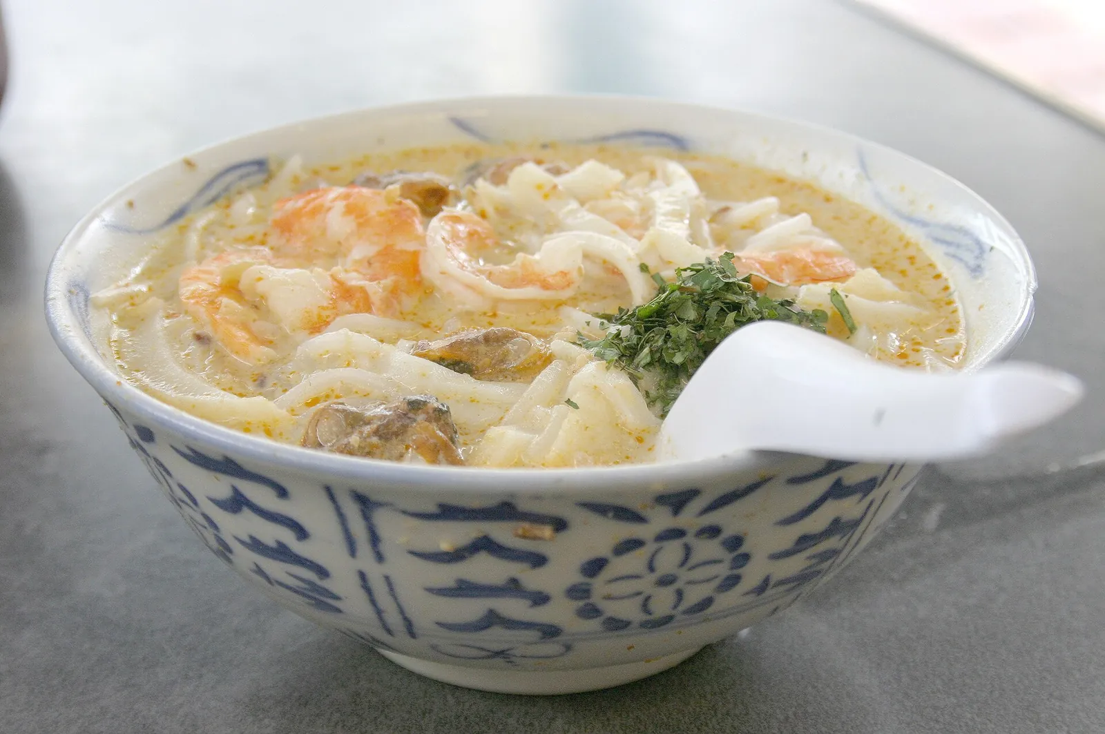 A bowl of Katong laksa with rice noodles and broth