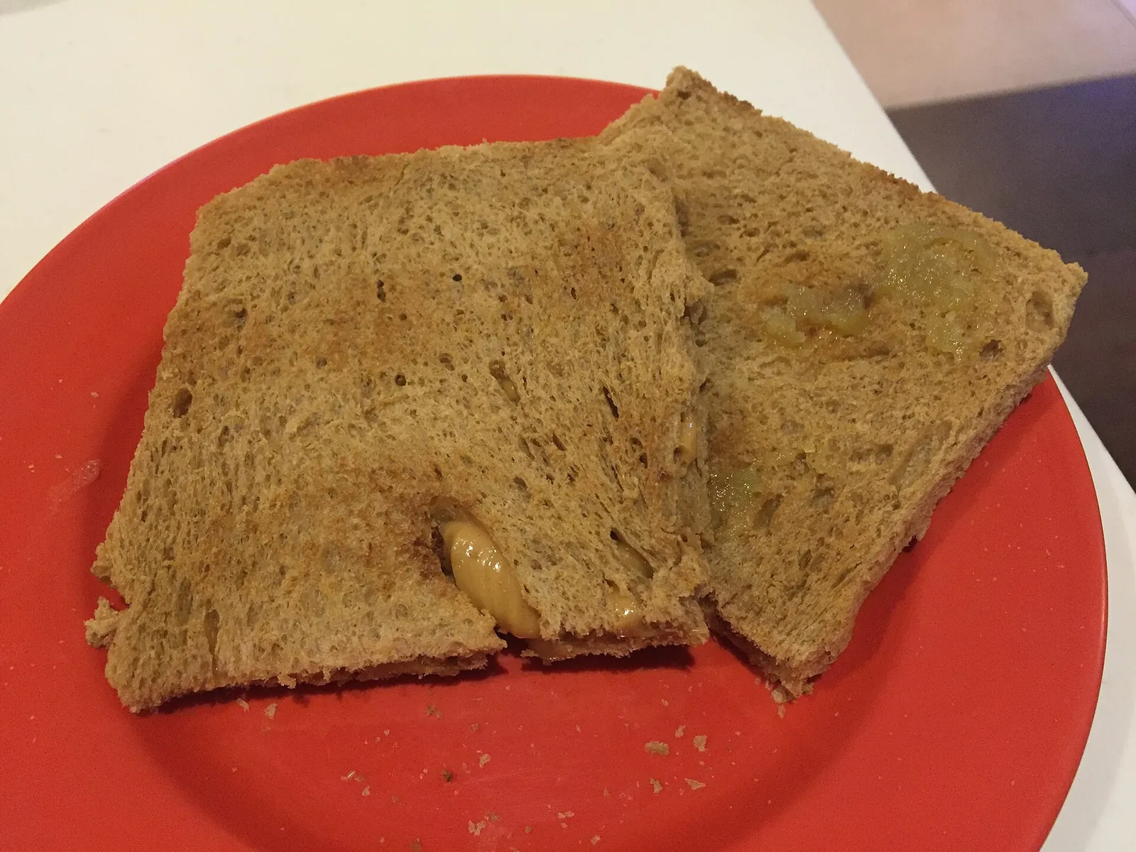 Kaya toast sandwiches on a red plate at Ya Kun Kaya Toast in Singapore