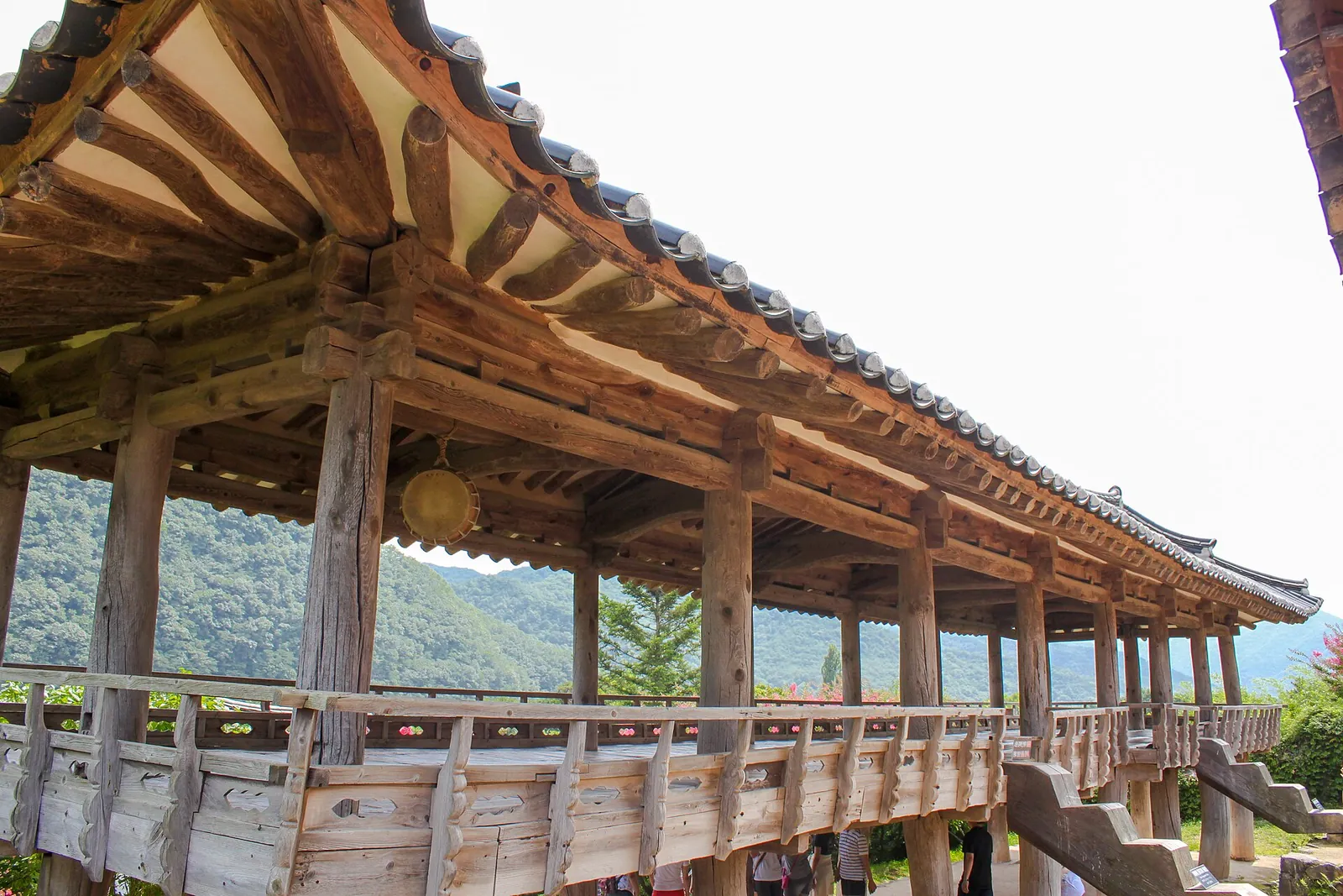 The long wooden Mandaeru pavilion at Byeongsanseowon in Andong, with hills behind