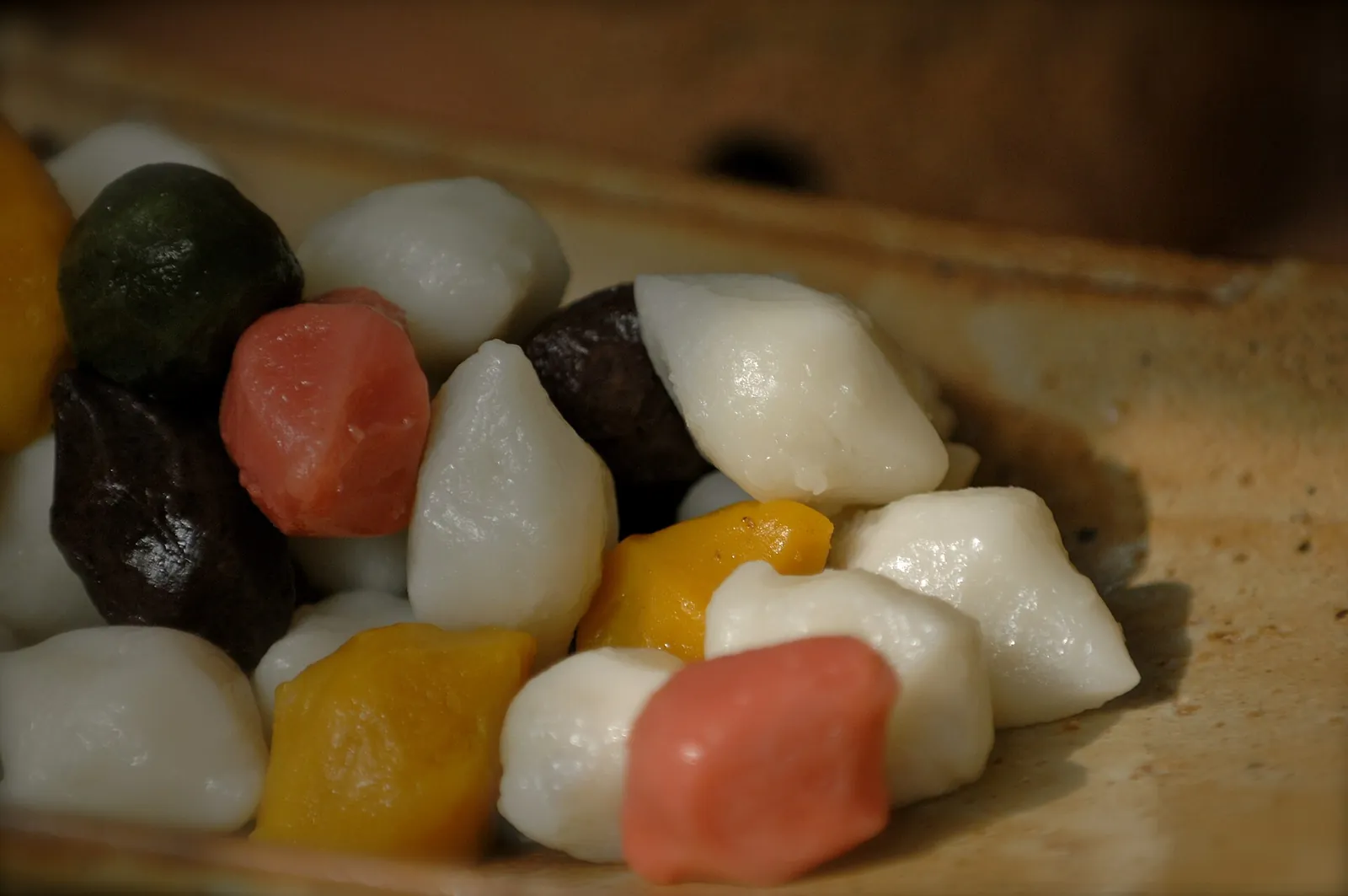 Close-up of colourful songpyeon rice cakes in white, green, pink, yellow and brown