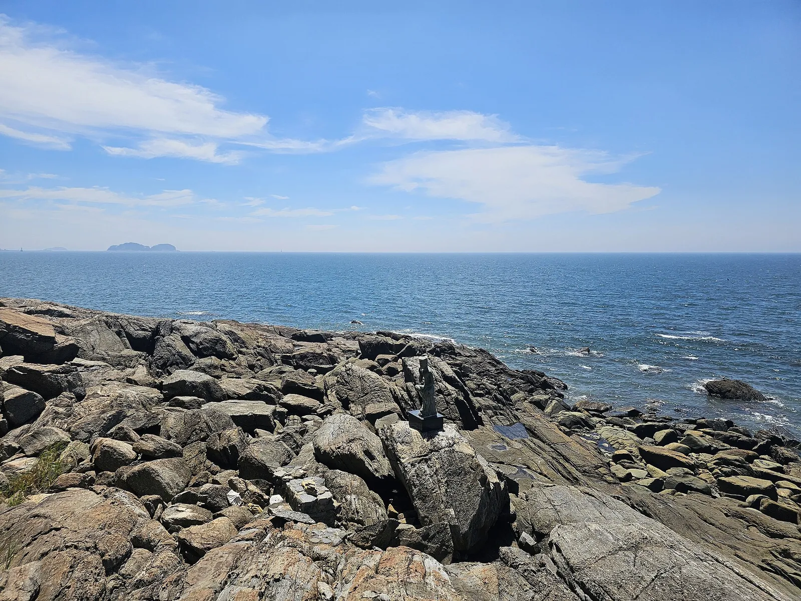 Rocky shore and open sea seen from Sanghwawon on Jukdo, Boryeong, with islands on the horizon