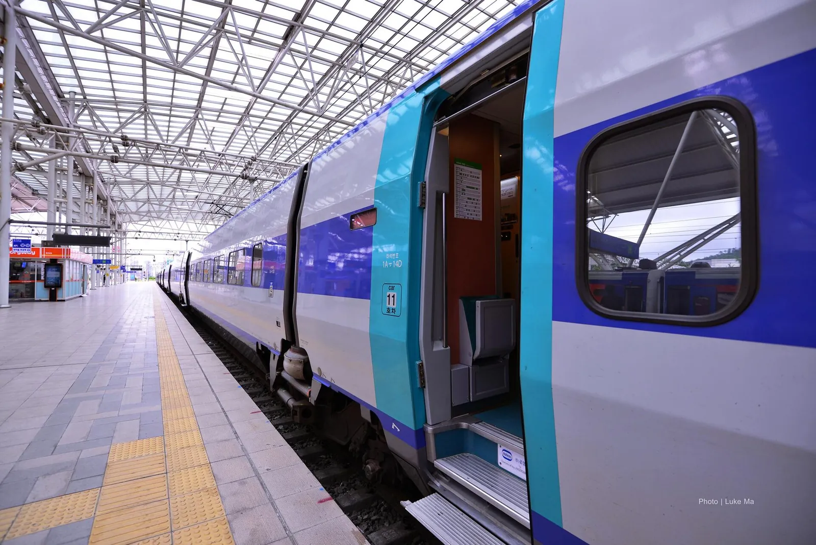 A KTX-I high-speed train standing at a platform in Seoul Station with its door open