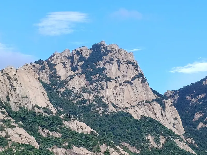 Granite summit massif of Baegundae in Bukhansan National Park under a blue sky