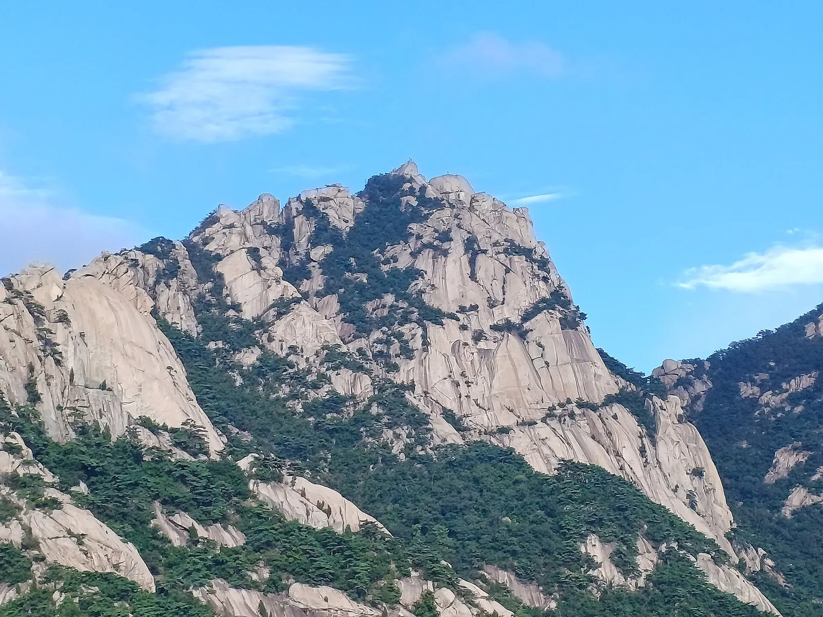 Granite summit massif of Baegundae in Bukhansan National Park under a blue sky