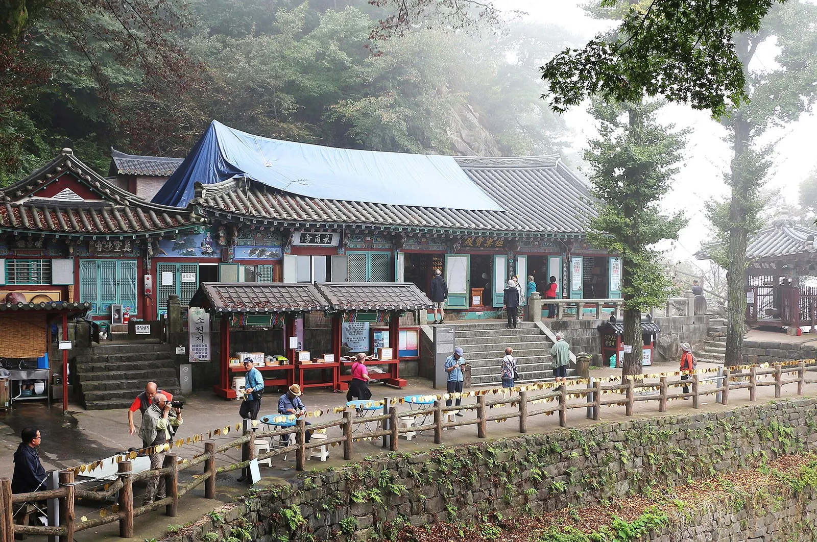 Wooden halls of Goransa Temple on a terrace among trees at the foot of the Busosan cliffs in Buyeo
