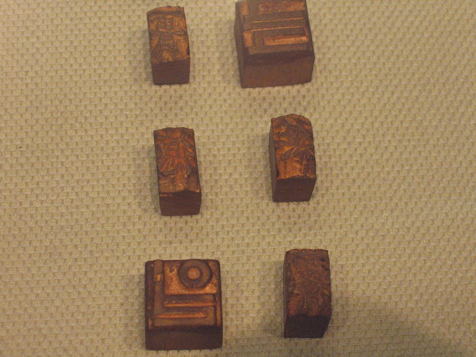 Small antique metal type blocks displayed on a beige cloth at the Cheongju Early Printing Museum