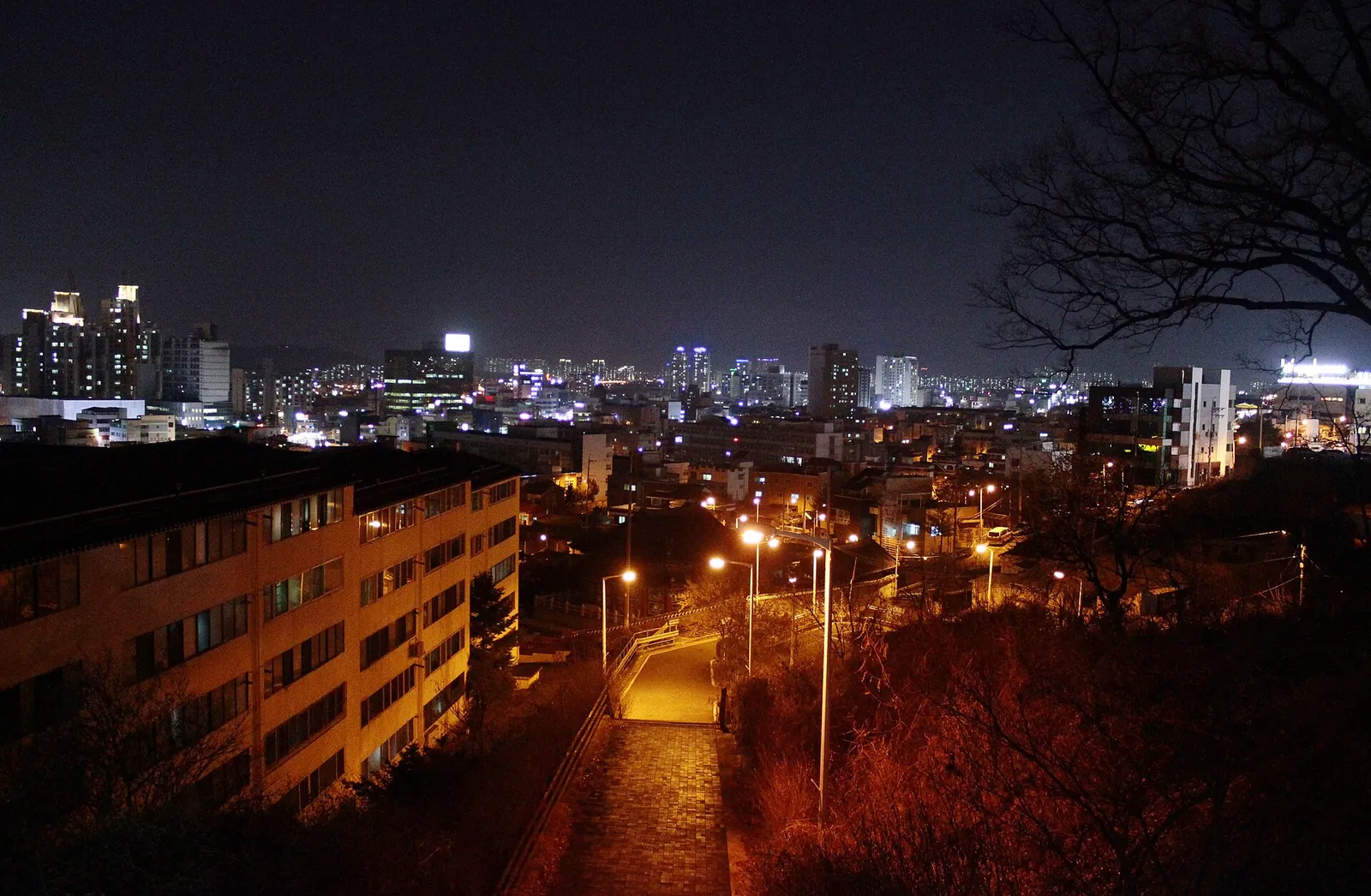 Cheongju's old town at night seen from above, with lit apartment towers and streets below