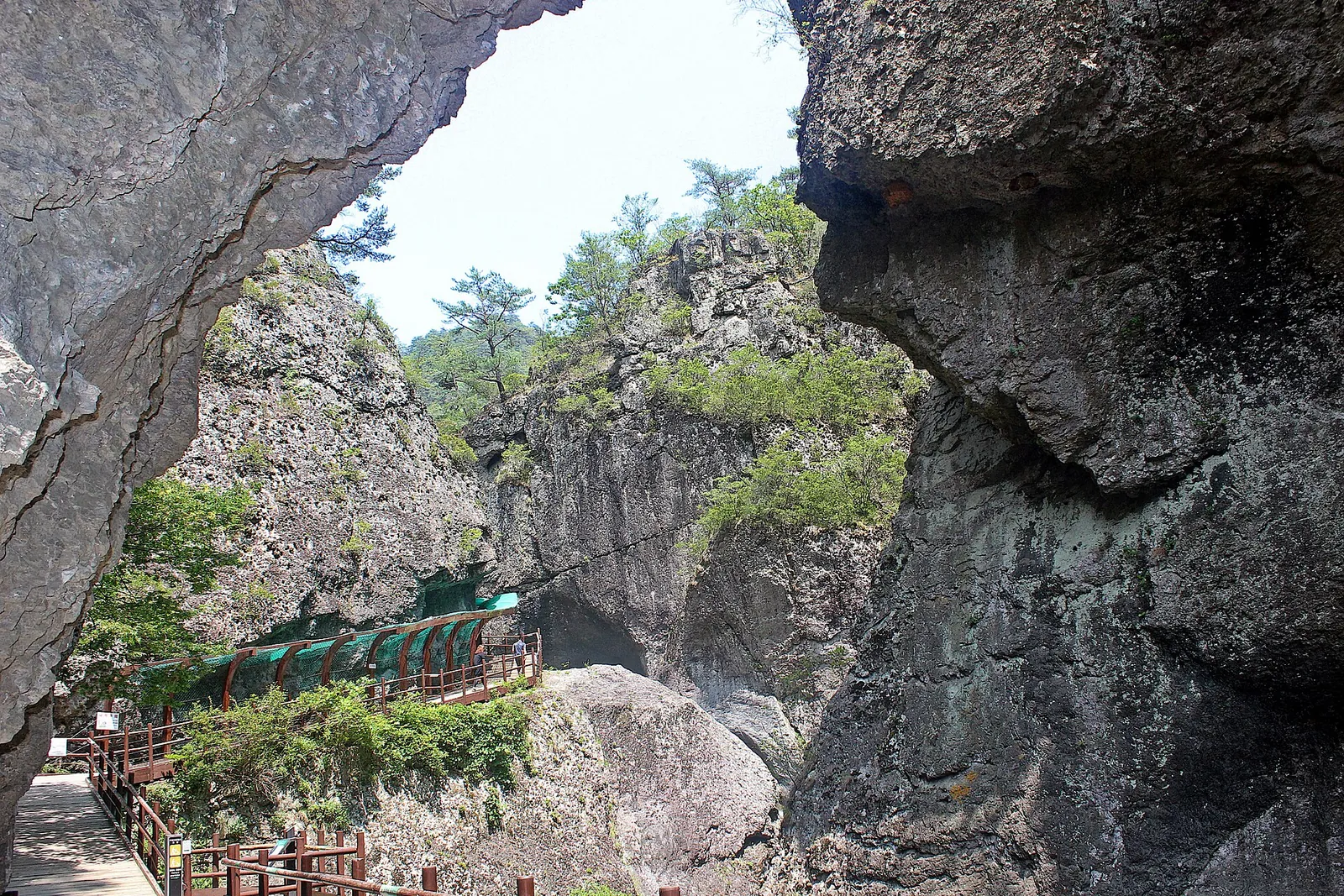 Wooden walkway between towering rock walls in the Juwangsan valley
