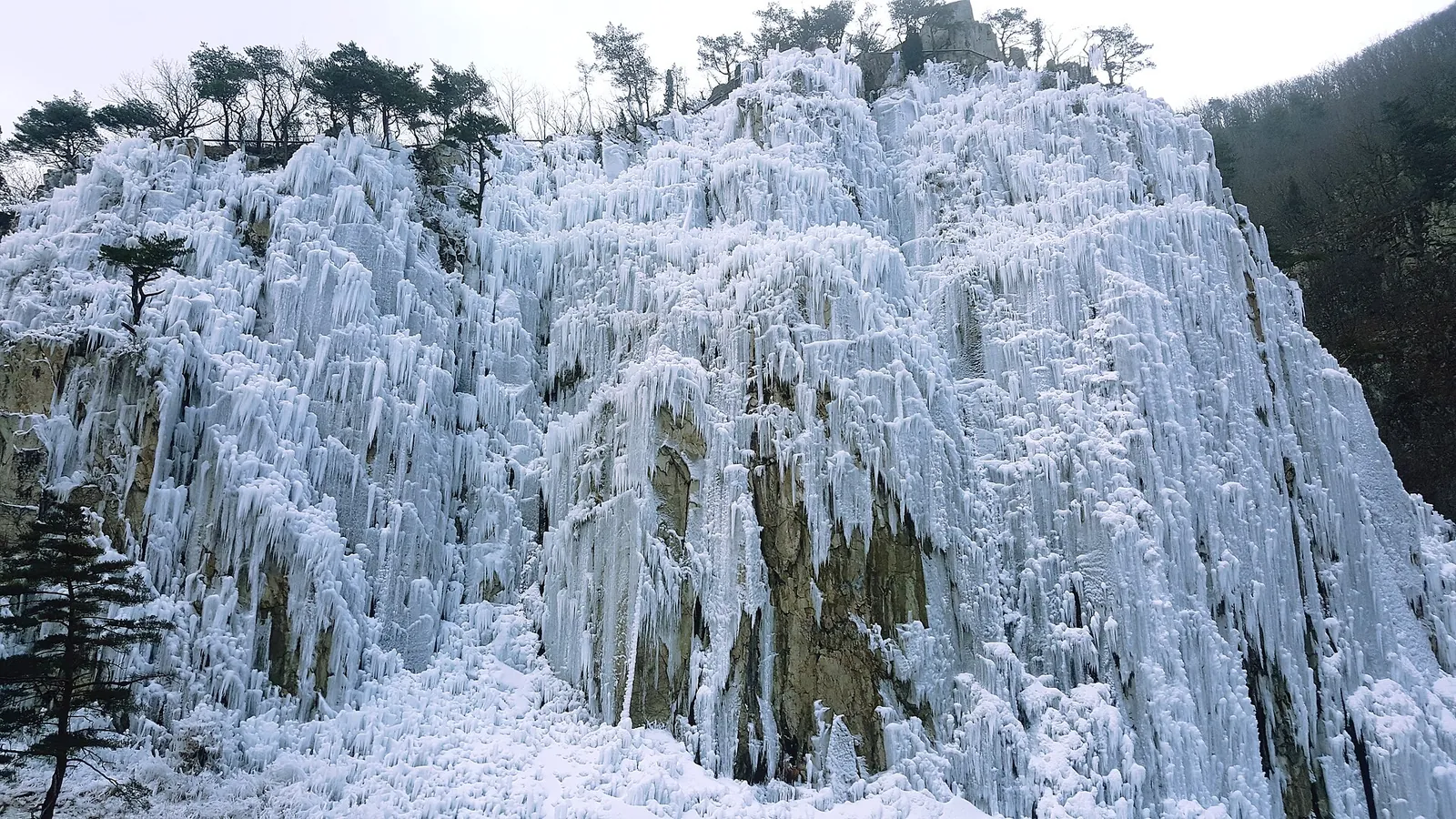 Frozen waterfall covering a cliff at Eoreumgol in Cheongsong in winter