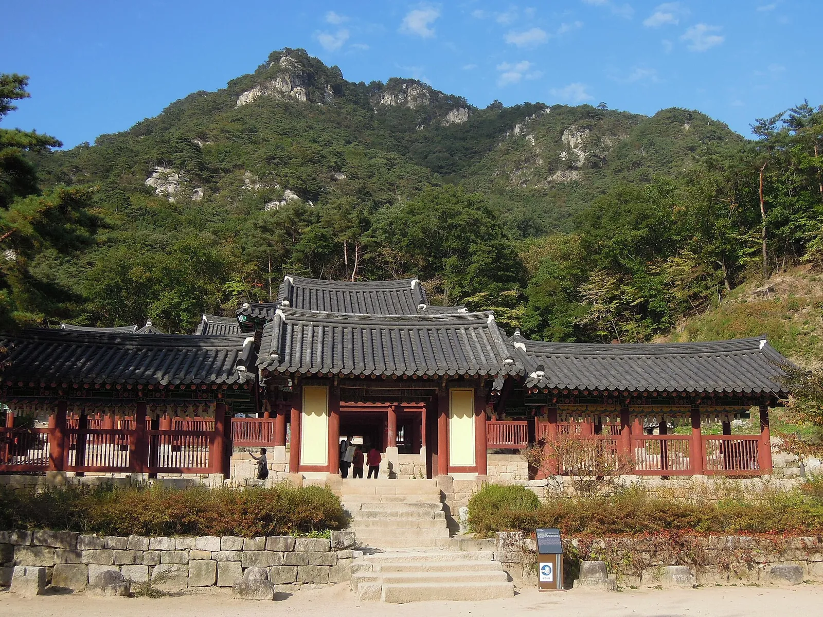 Halls of Cheongpyeongsa Temple below rocky, forested Obongsan Mountain in Chuncheon