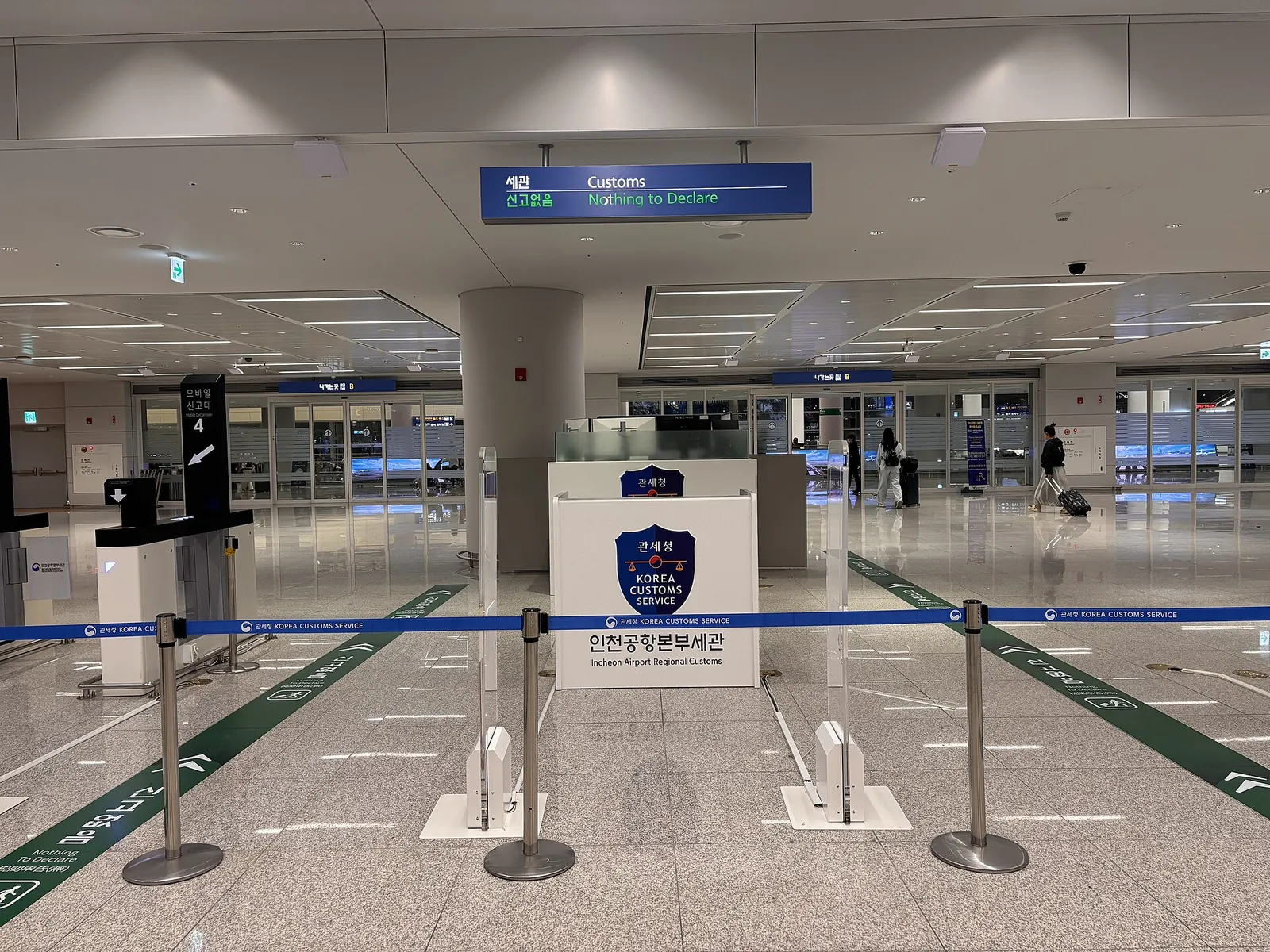 Customs inspection area at Incheon International Airport with queue barriers and an Incheon Customs sign