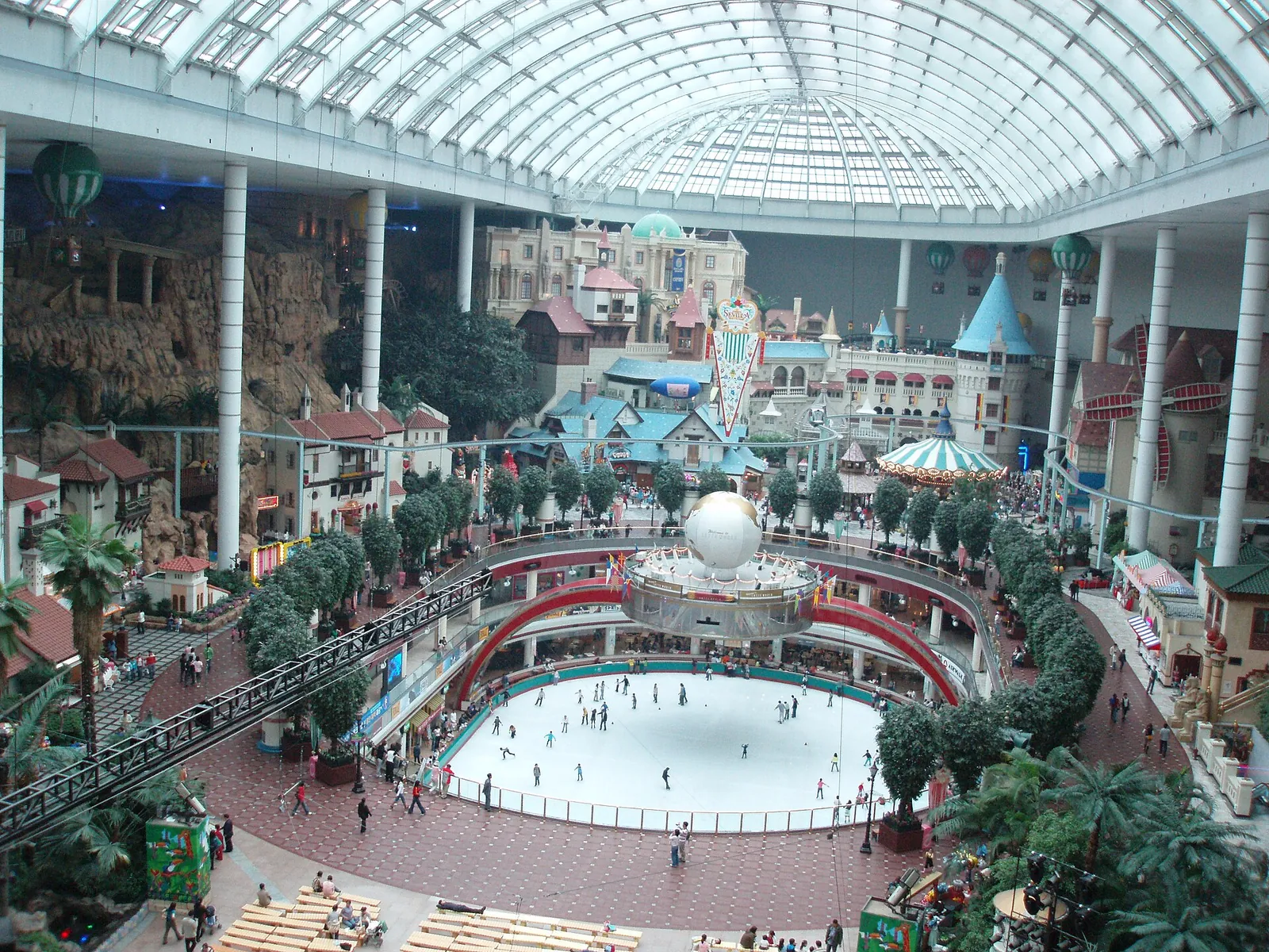The glass-roofed indoor hall of Lotte World Adventure with an ice rink at its centre