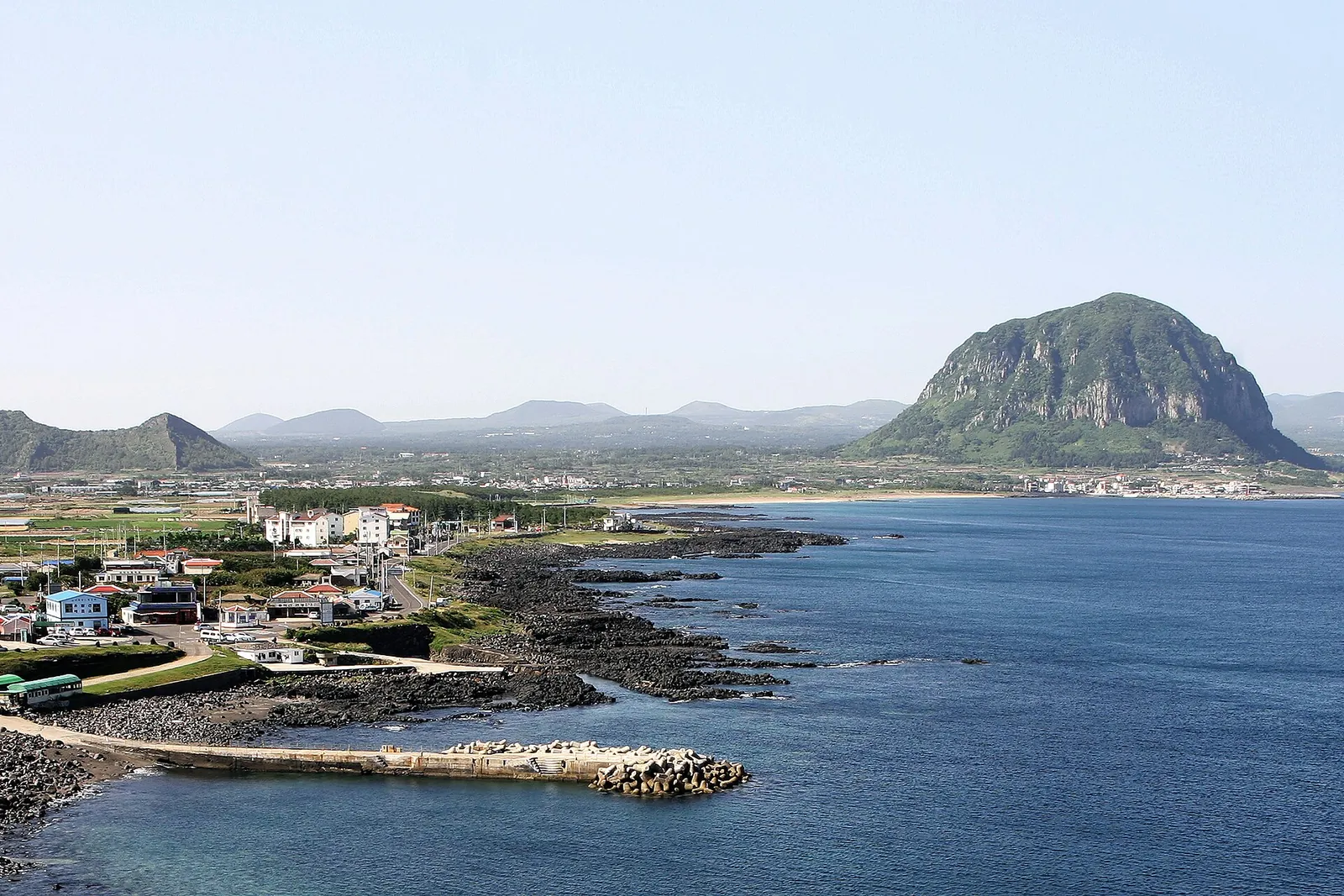 Sanbangsan mountain rising behind the village and harbour on the Sagye coast of Jeju Island