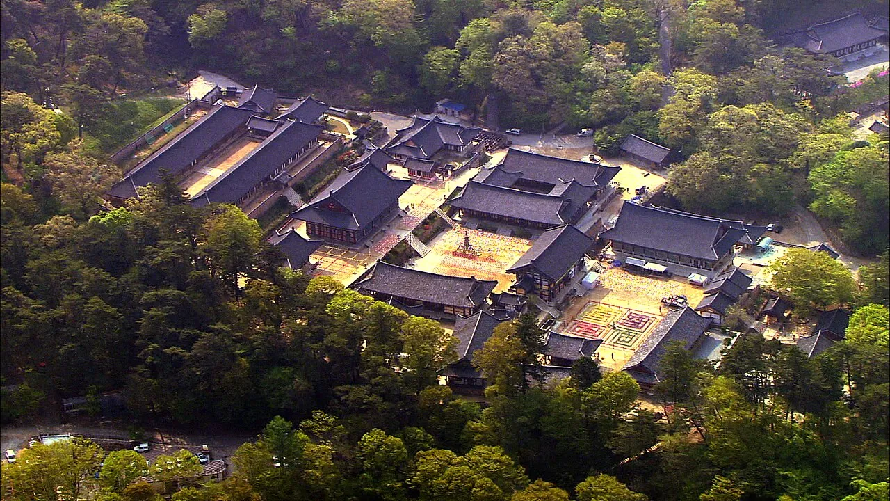 Aerial view of the Haeinsa temple complex surrounded by dense forest on Gayasan