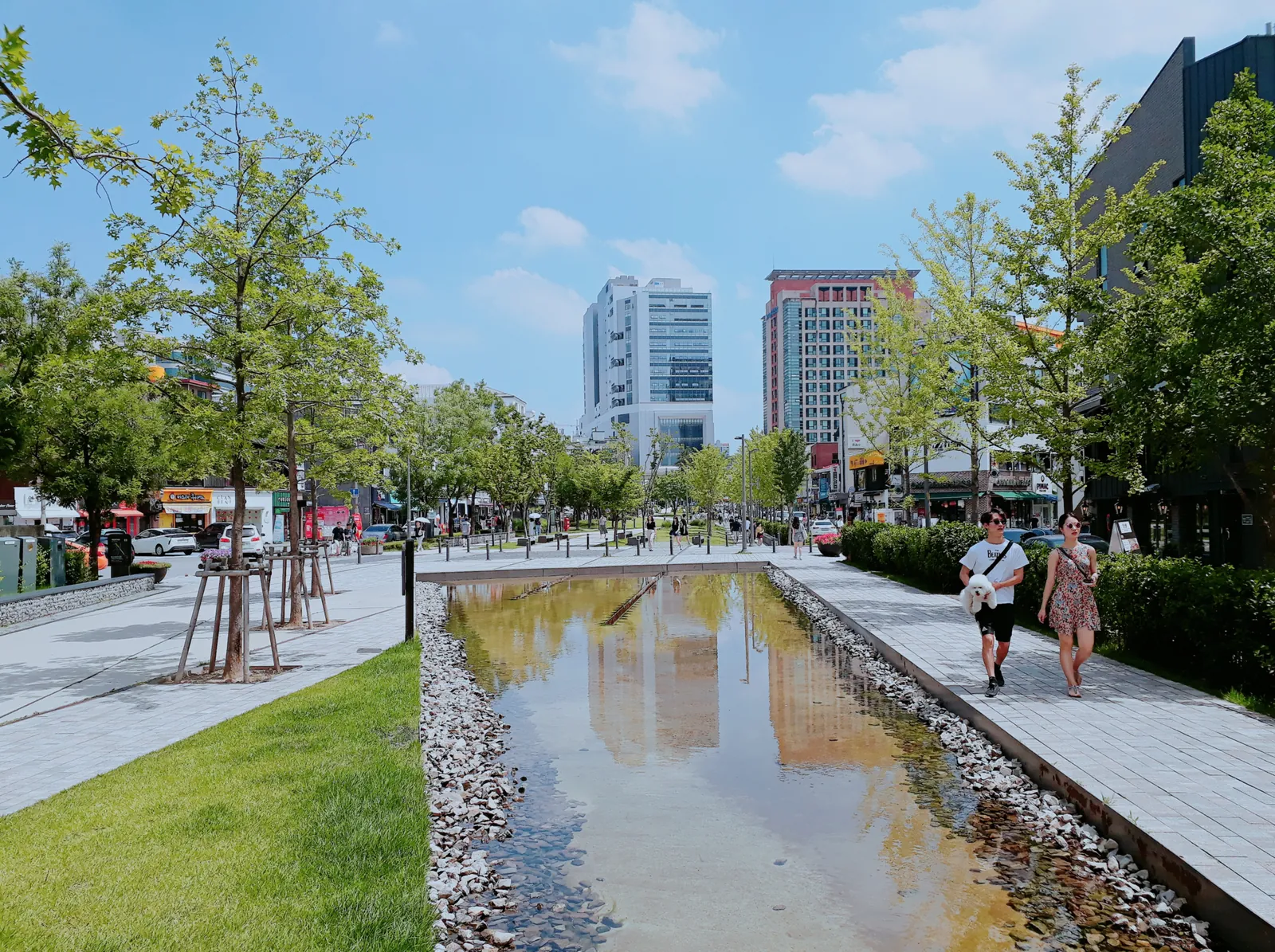 A long shallow water channel between lawns and paved paths in Yeontral Park, the Yeonnam-dong section of the Gyeongui Line Forest Park in Seoul