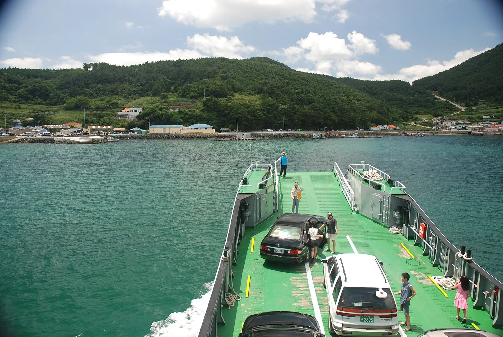 Car ferry with vehicles on deck arriving at Chubongdo island in Tongyeong