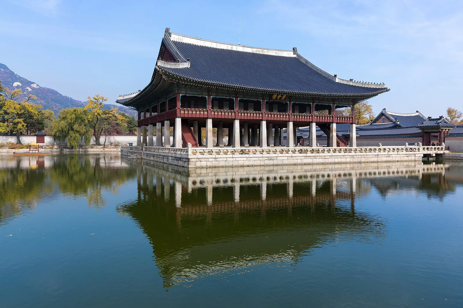 Gyeonghoeru pavilion reflected in its pond at Gyeongbokgung Palace on a clear day