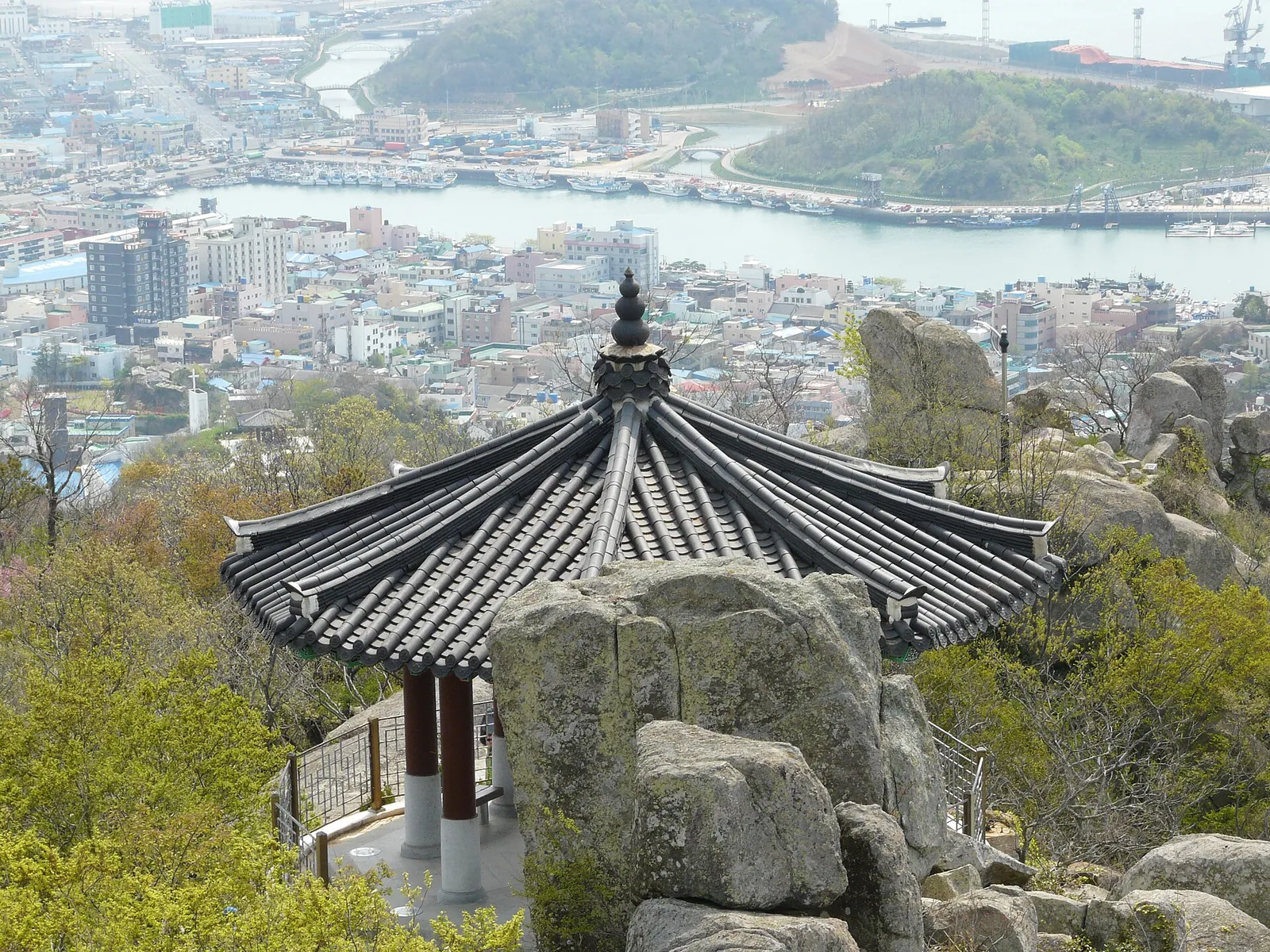 Traditional pavilion among granite rocks on Yudalsan, with Mokpo's rooftops and harbour below