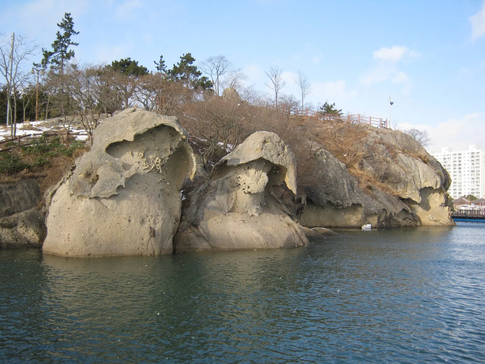 Two weathered sandstone rocks rising from the water on the Mokpo coast
