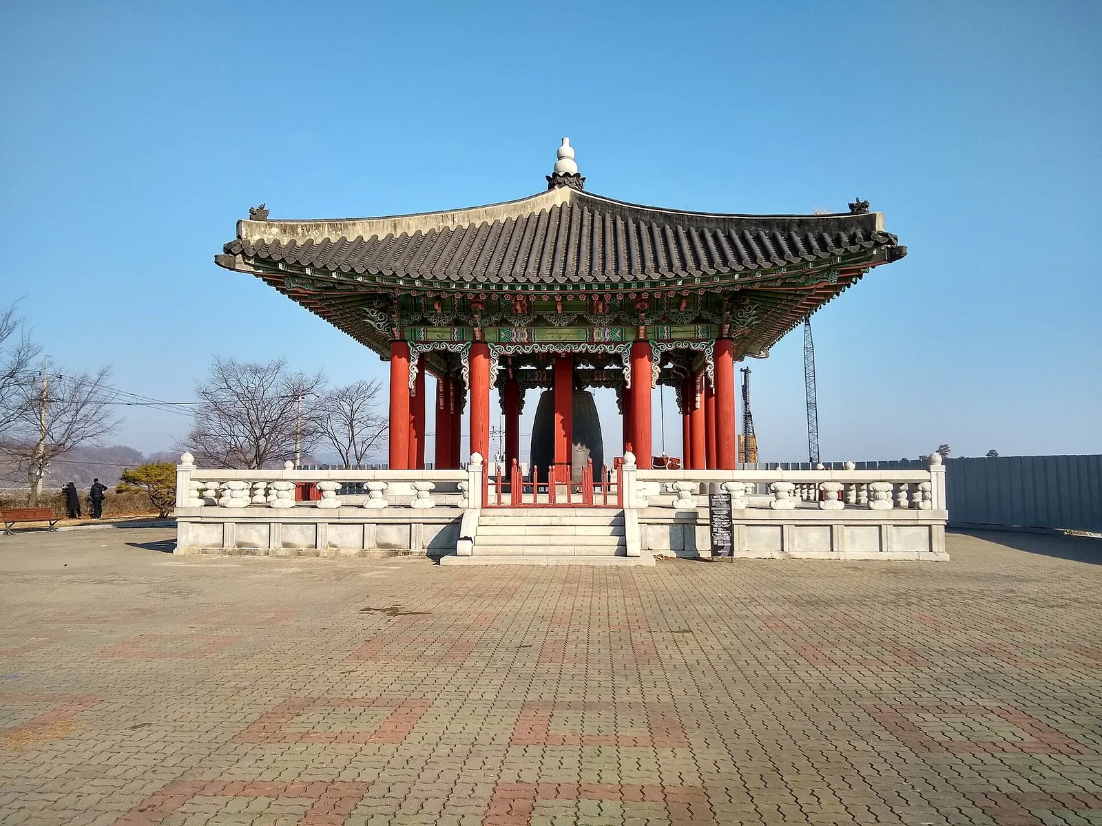 Red-pillared pavilion housing the Peace Bell on a paved terrace at Imjingak