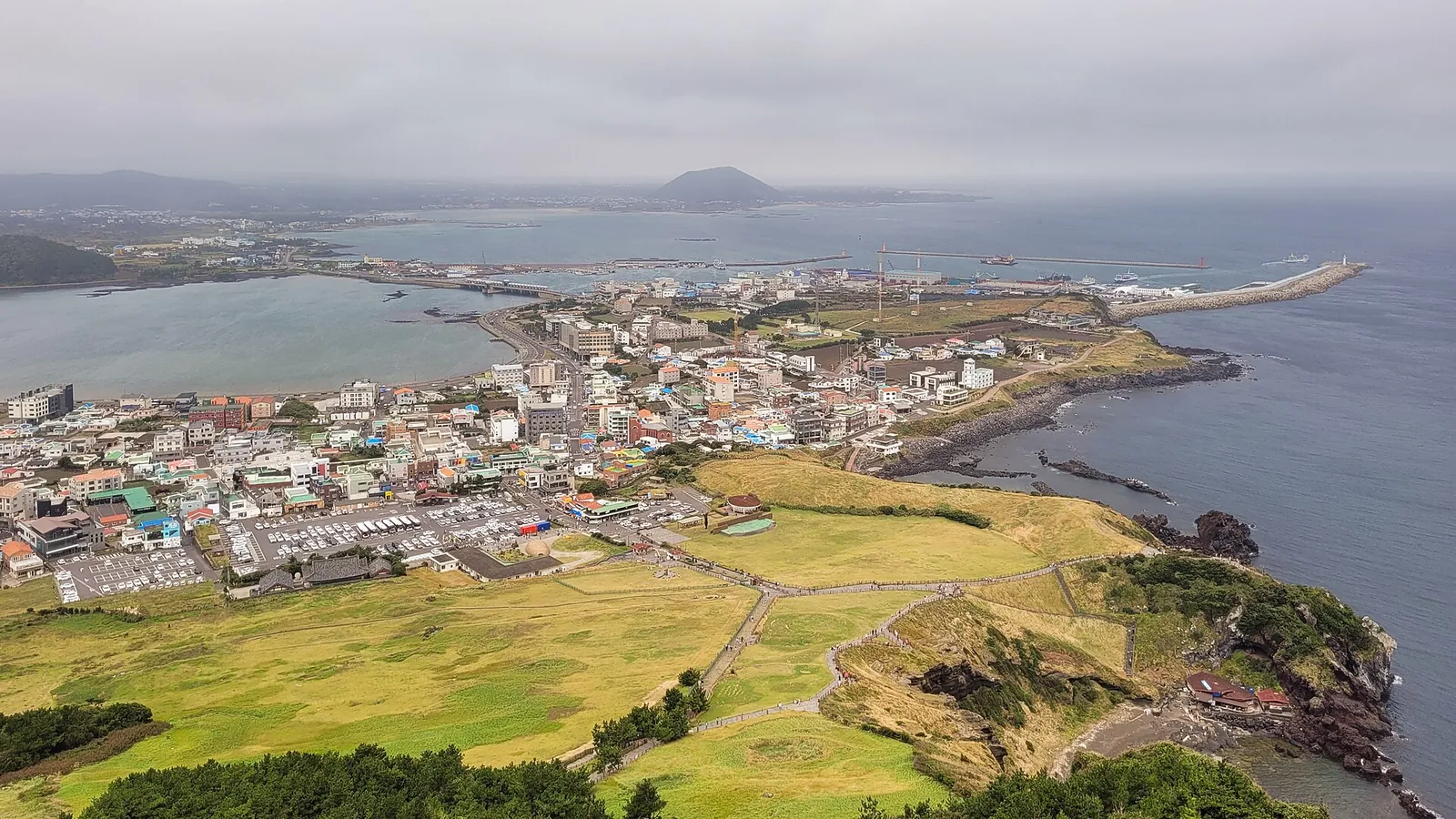Seongsan-ri village, its harbour and the green neck of land seen from the slopes of Seongsan Ilchulbong