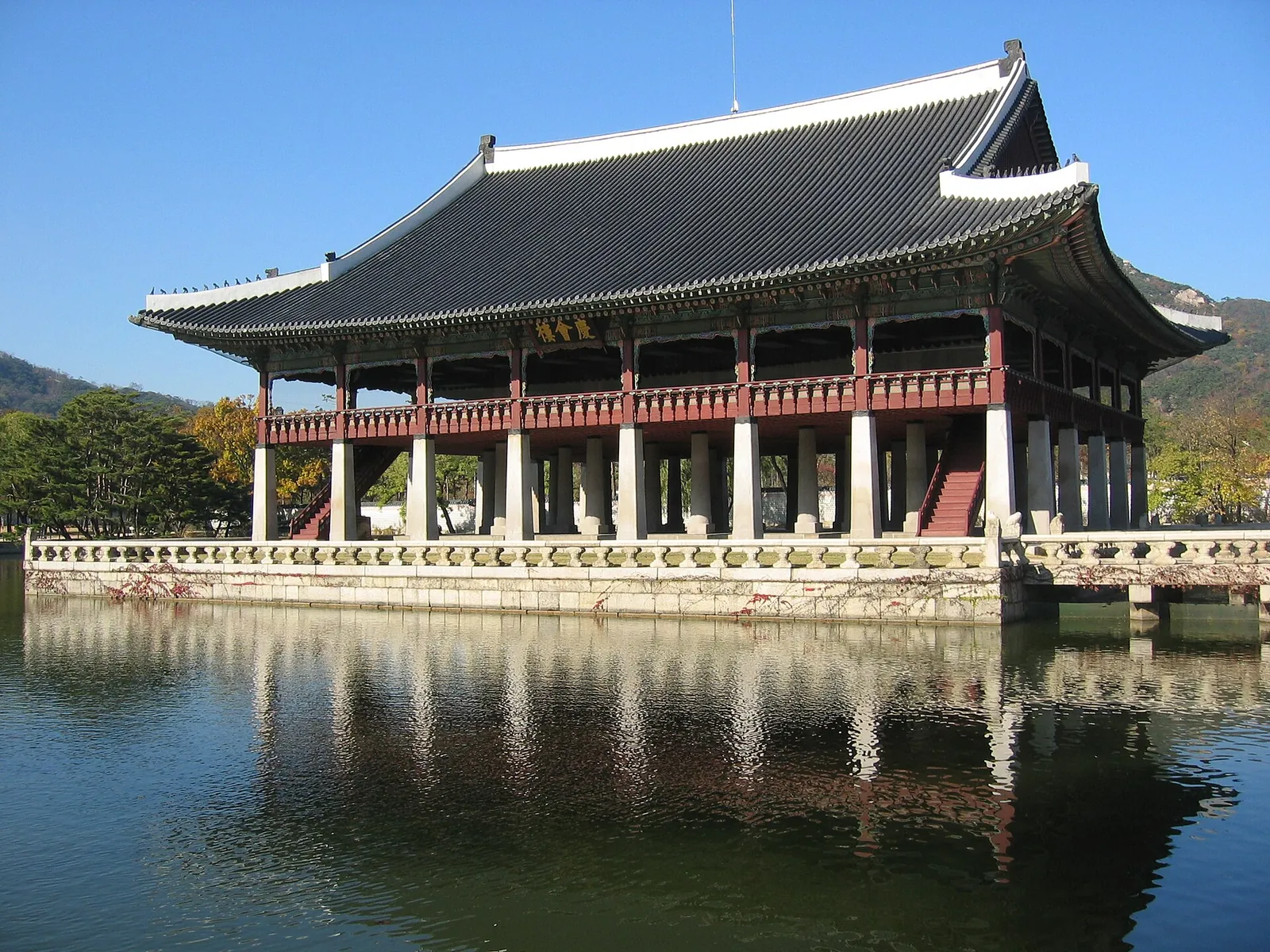 Gyeonghoeru Pavilion at Gyeongbokgung Palace reflected in its pond under a blue sky