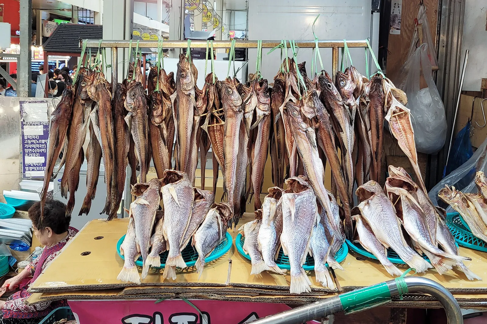Dried fish hung and stacked on a stall at Sokcho Central Market