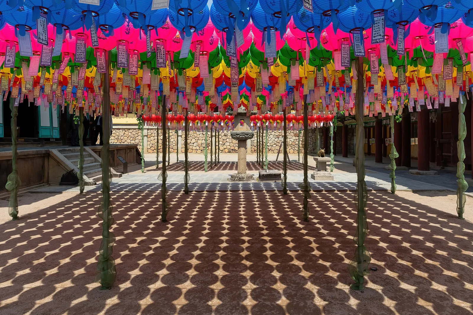 Rows of colourful paper lanterns over a stone courtyard at Bulguksa temple