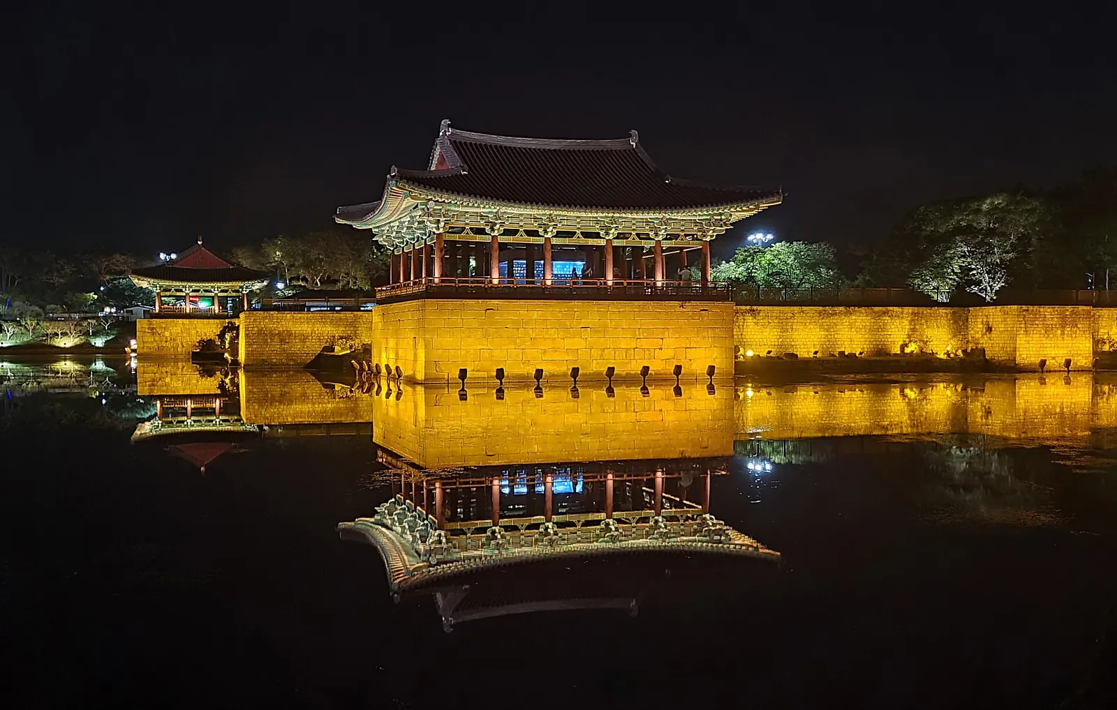 Donggung Palace pavilions lit at night and reflected in Wolji Pond