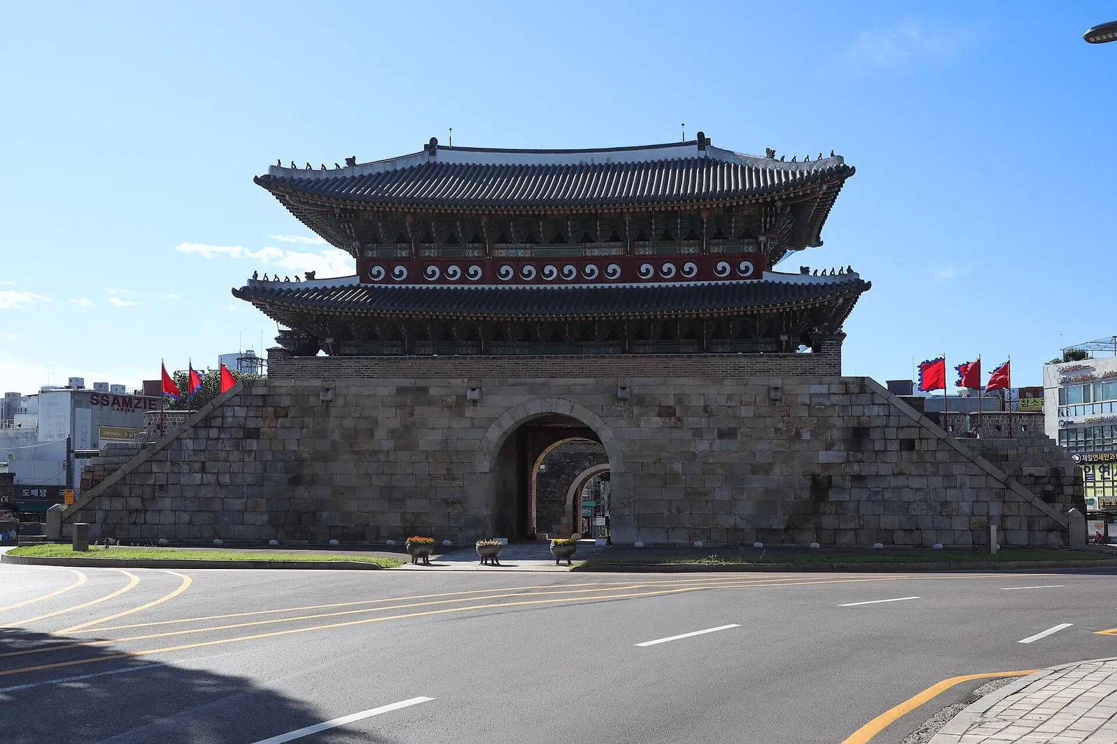 Paldalmun, the two-storey south gate of Hwaseong Fortress, on its stone base under a clear blue sky