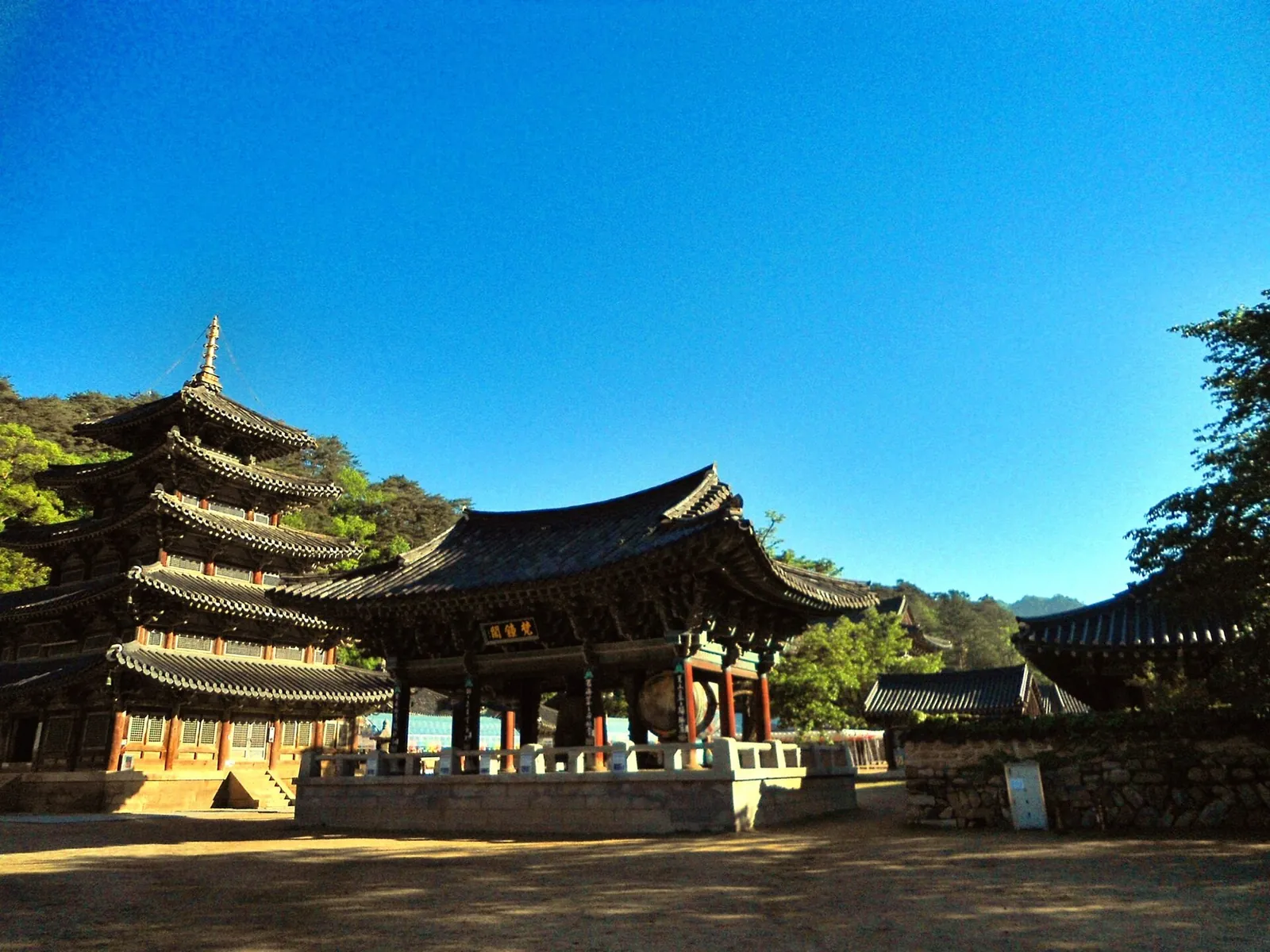 The five-storey wooden Palsangjeon pagoda and temple halls at Beopjusa under a clear blue sky