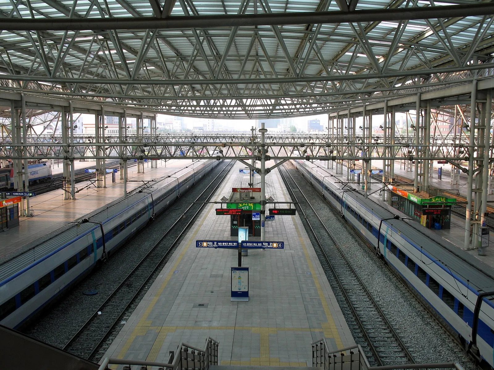 Long covered platforms at Seoul Station with KTX trains waiting on both sides