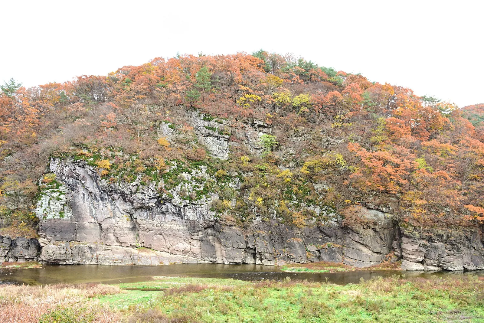 A low cliff above the Bangucheon Stream in autumn, the site of the Bangudae petroglyphs in Daegok-ri, Ulju