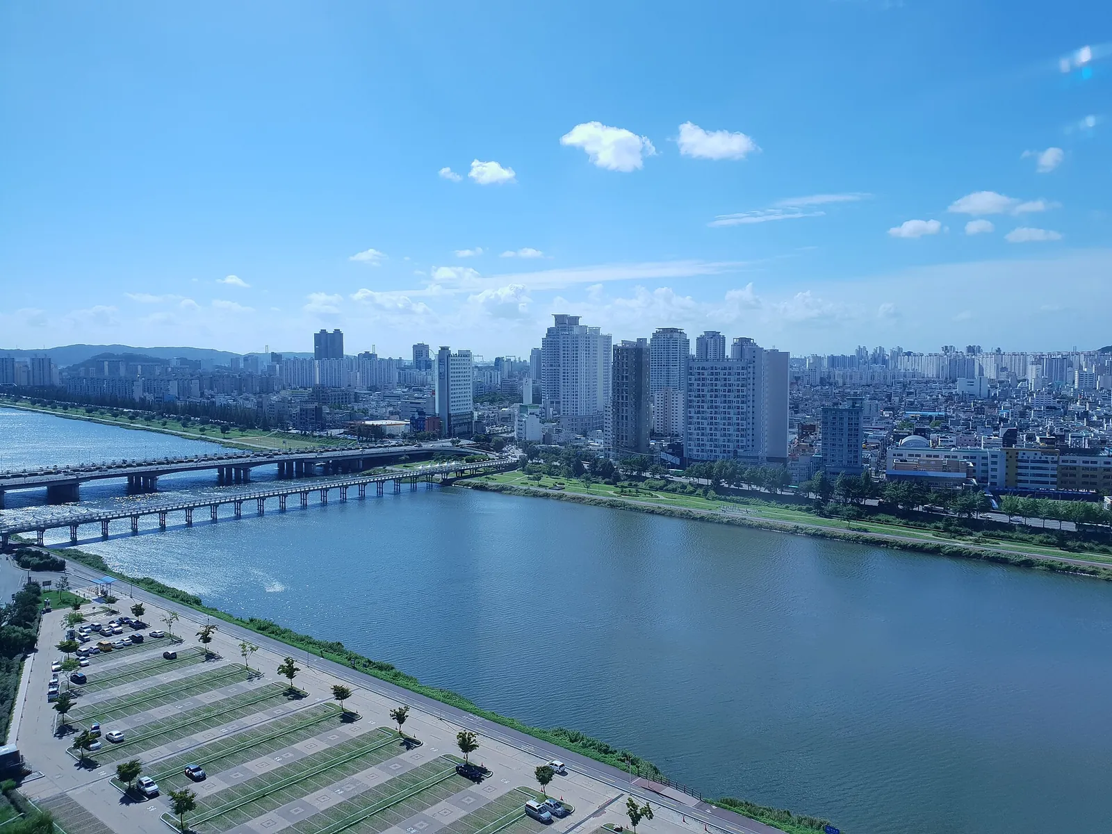 View down the Taehwagang in Ulsan from a riverside hotel, with bridges and the high-rise districts of Samsan-dong and Sinjeong-dong