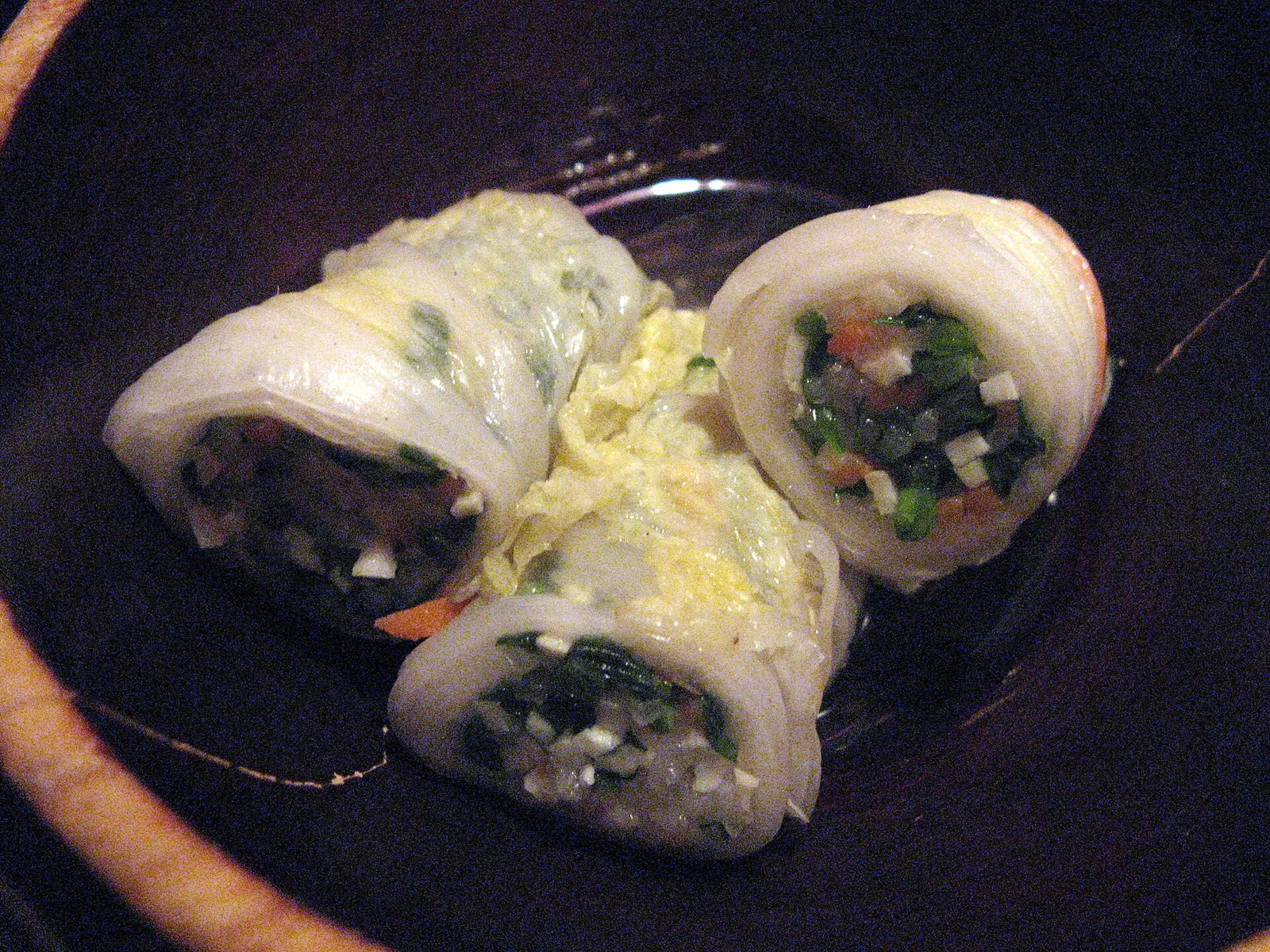 Steamed napa cabbage rolls stuffed with vegetables, cut open to show the filling