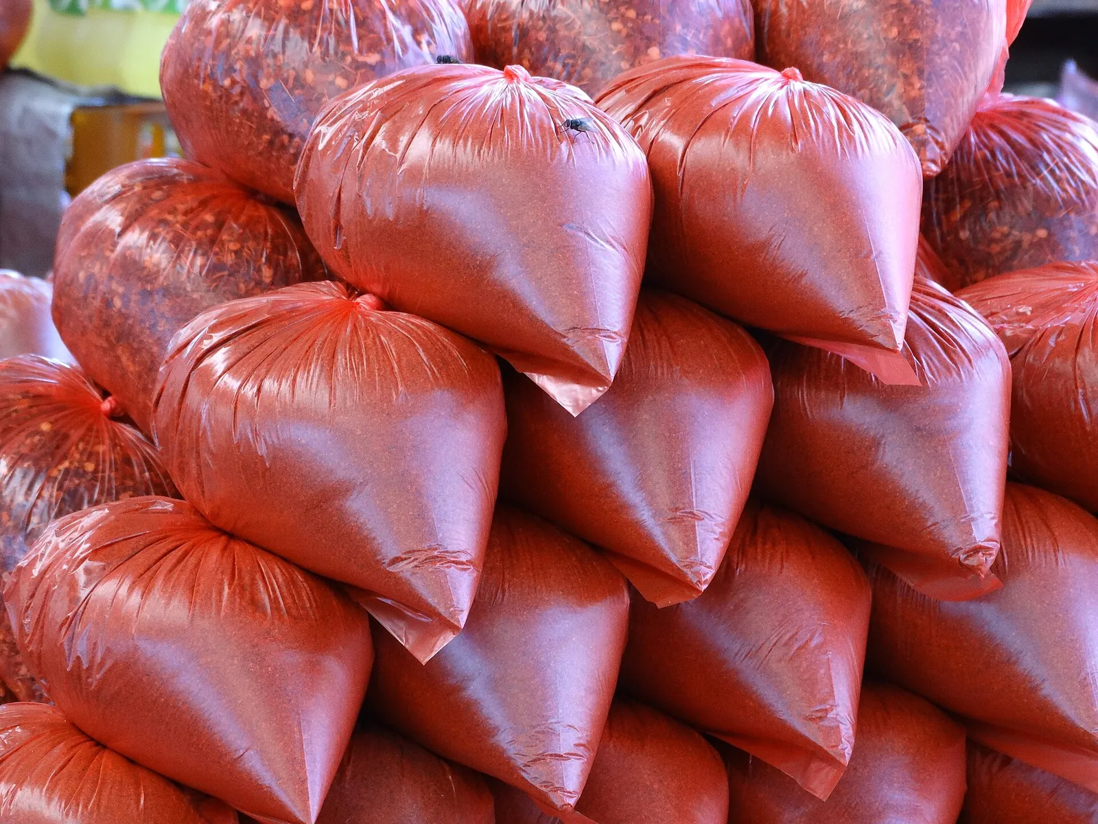 Sacchi rossi di spezie accatastati su una bancarella del mercato nel quartiere di Pettah