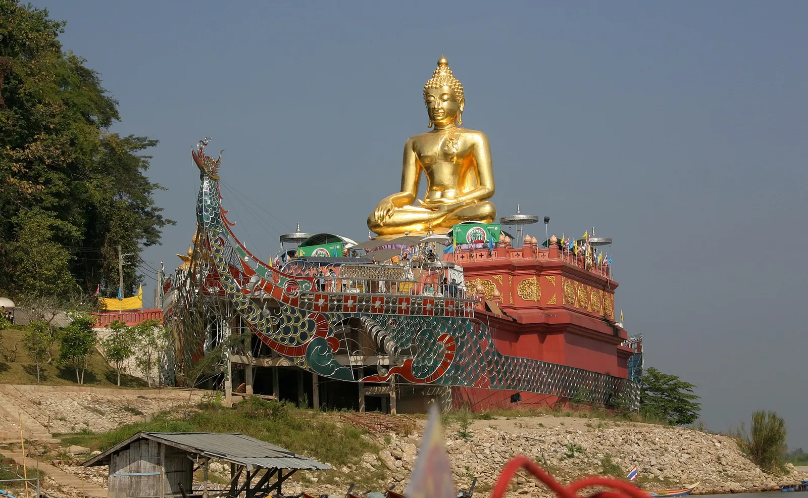 A huge golden seated Buddha on a boat-shaped base above the Mekong at the Golden Triangle