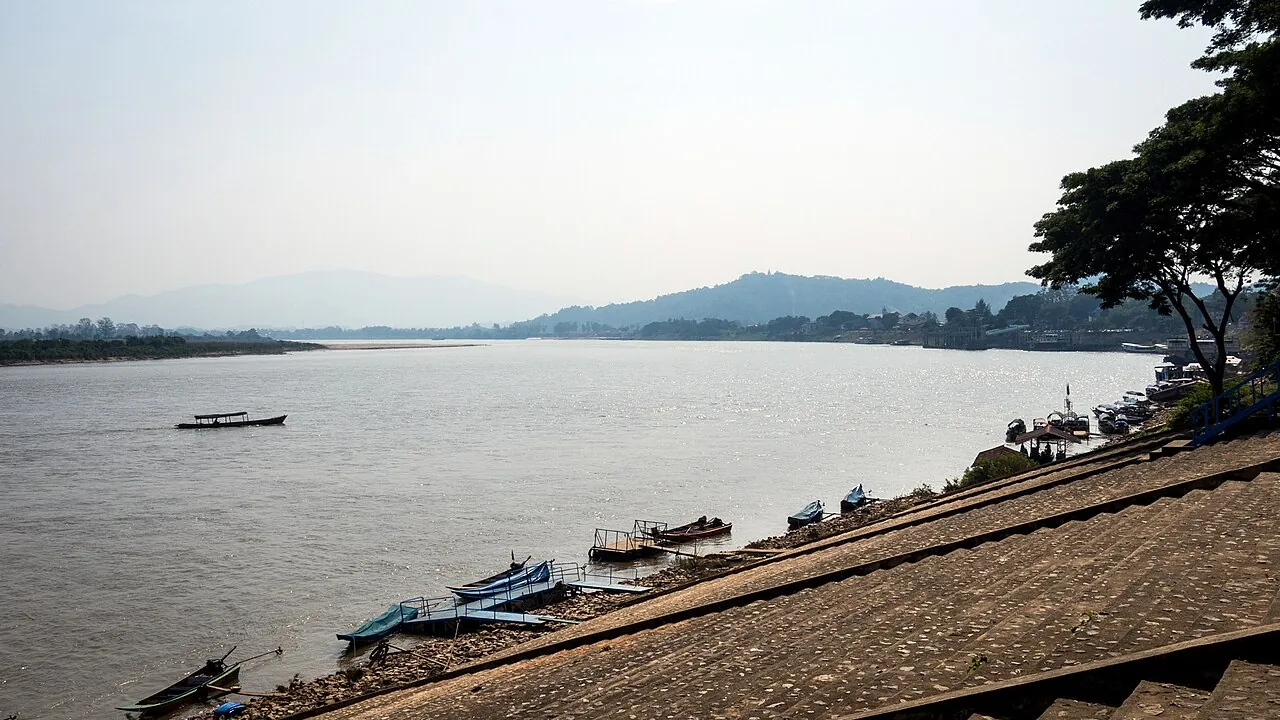 Longtail boats moored on the bank of the Mekong at Chiang Saen on a hazy day