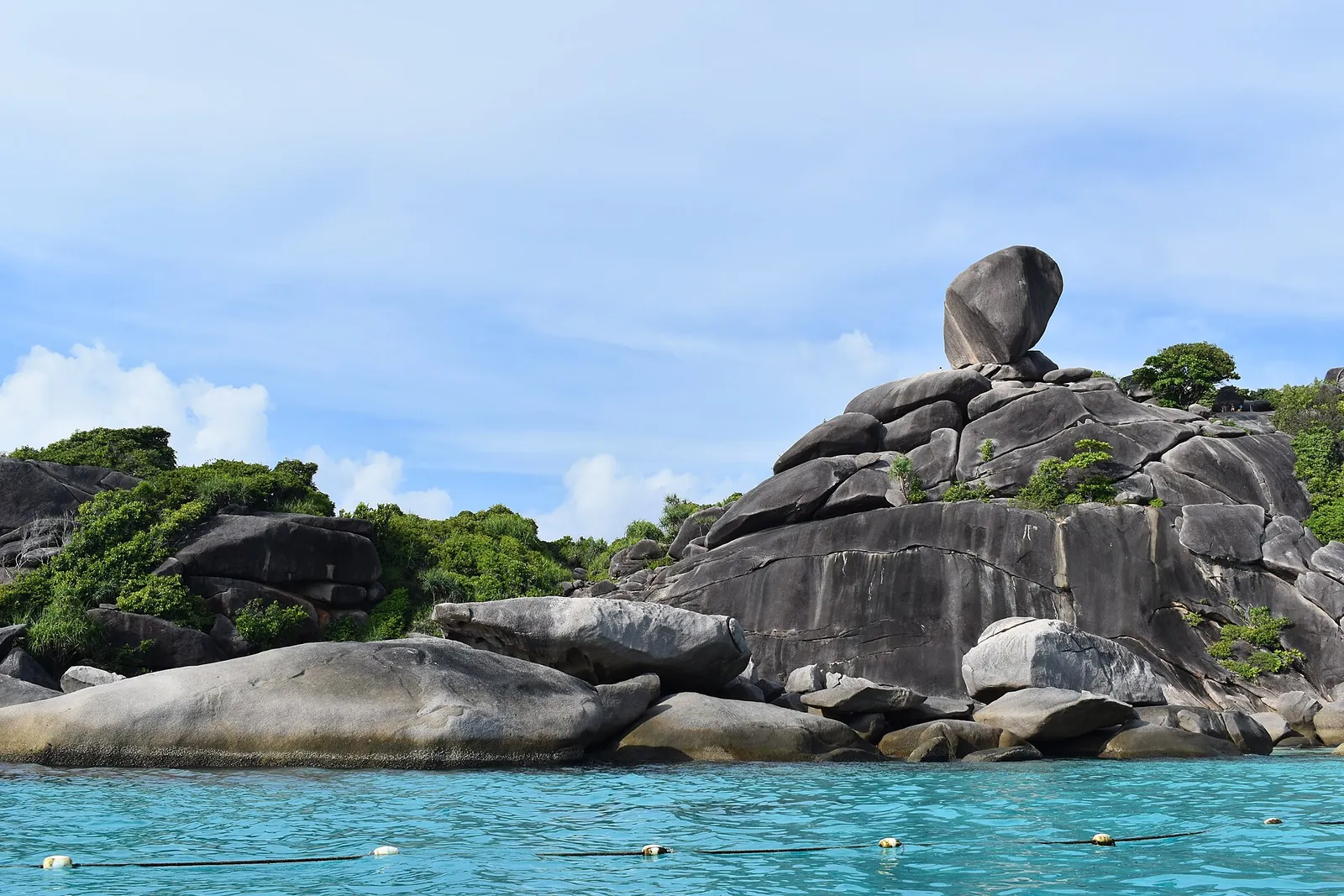 The balanced granite boulder of Donald Duck Bay above turquoise water in the Similan Islands
