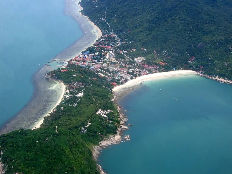 The Haad Rin peninsula of Koh Phangan with beaches on both sides seen from above