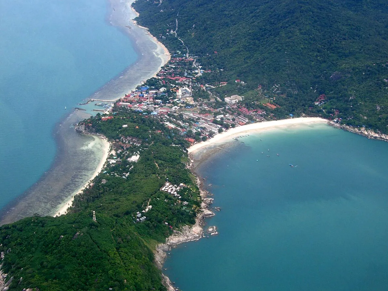 The Haad Rin peninsula of Koh Phangan with beaches on both sides seen from above