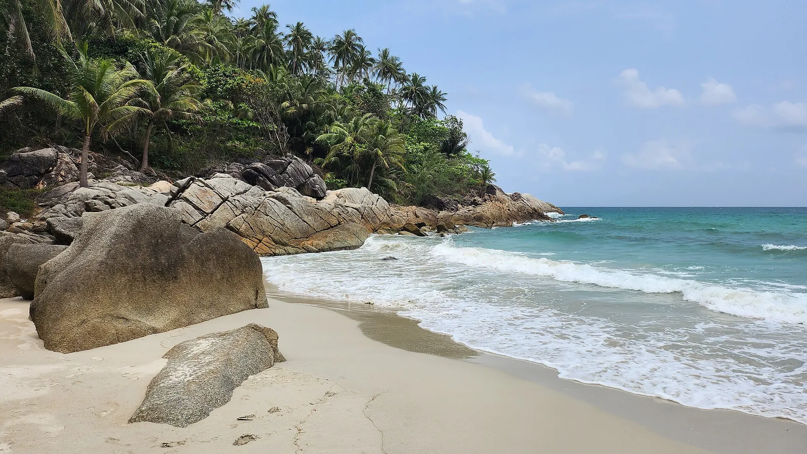 Granite boulders and palms at the edge of Bottle Beach on the north coast of Koh Phangan