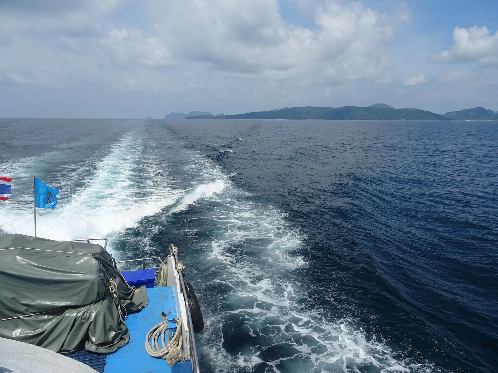 The wake of a ferry with Phi Phi Don and Phi Phi Leh on the horizon