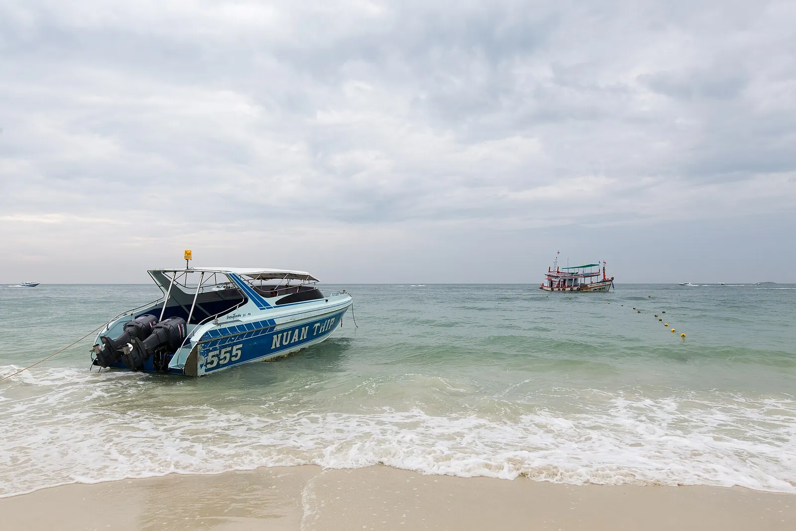 A speedboat pulled up on the sand at Koh Samet