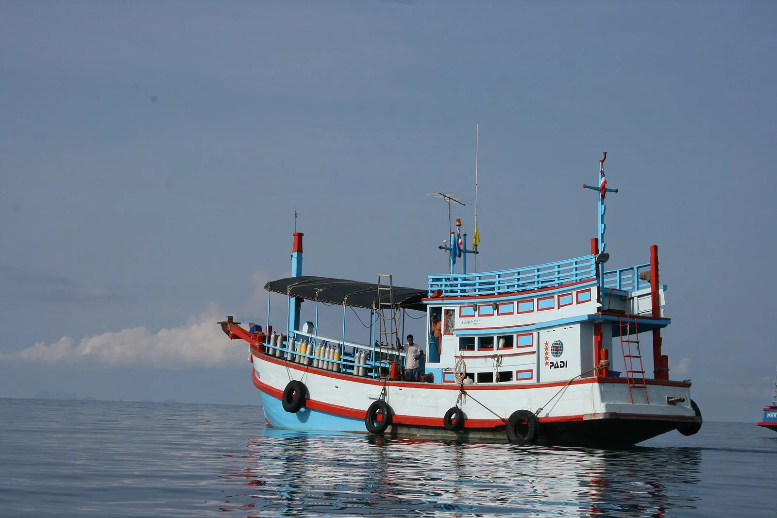 A traditional wooden dive boat anchored off Koh Tao